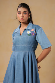 Zoomed-in view of the neckline and chest embroidery of the Daisydrift Handkerchief Dress, highlighting its collared V-neck and vibrant stitched daisies.