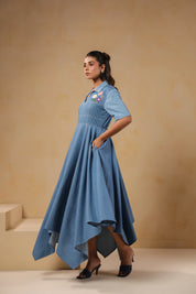 Side profile of the Daisydrift Handkerchief Dress featuring a flared silhouette, handkerchief hemline, and functional side pockets for added comfort.