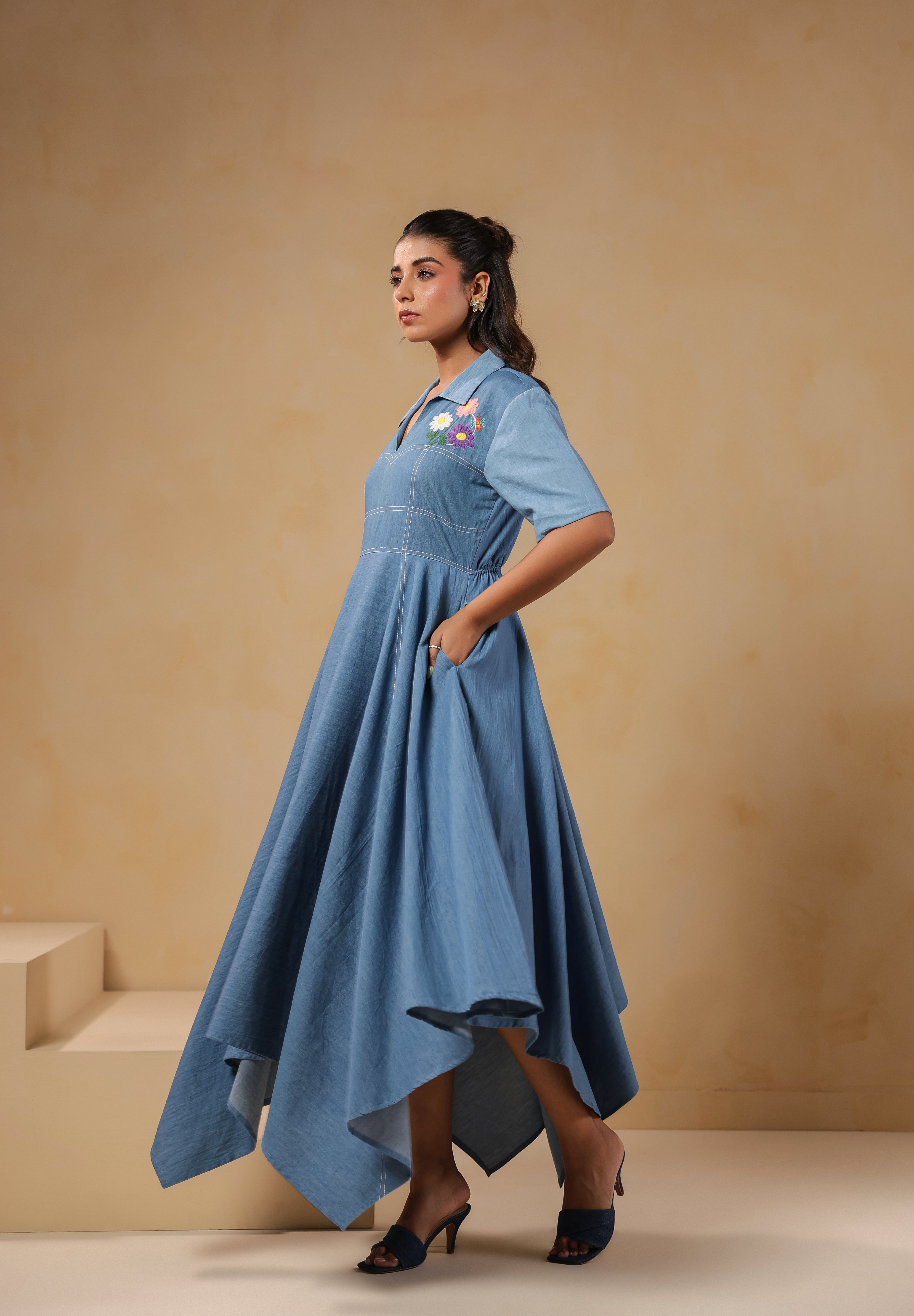 Side profile of the Daisydrift Handkerchief Dress featuring a flared silhouette, handkerchief hemline, and functional side pockets for added comfort.