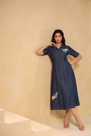 Angled view of Aqua Prism Midi Dress highlighting fitted waist and flowy hemline