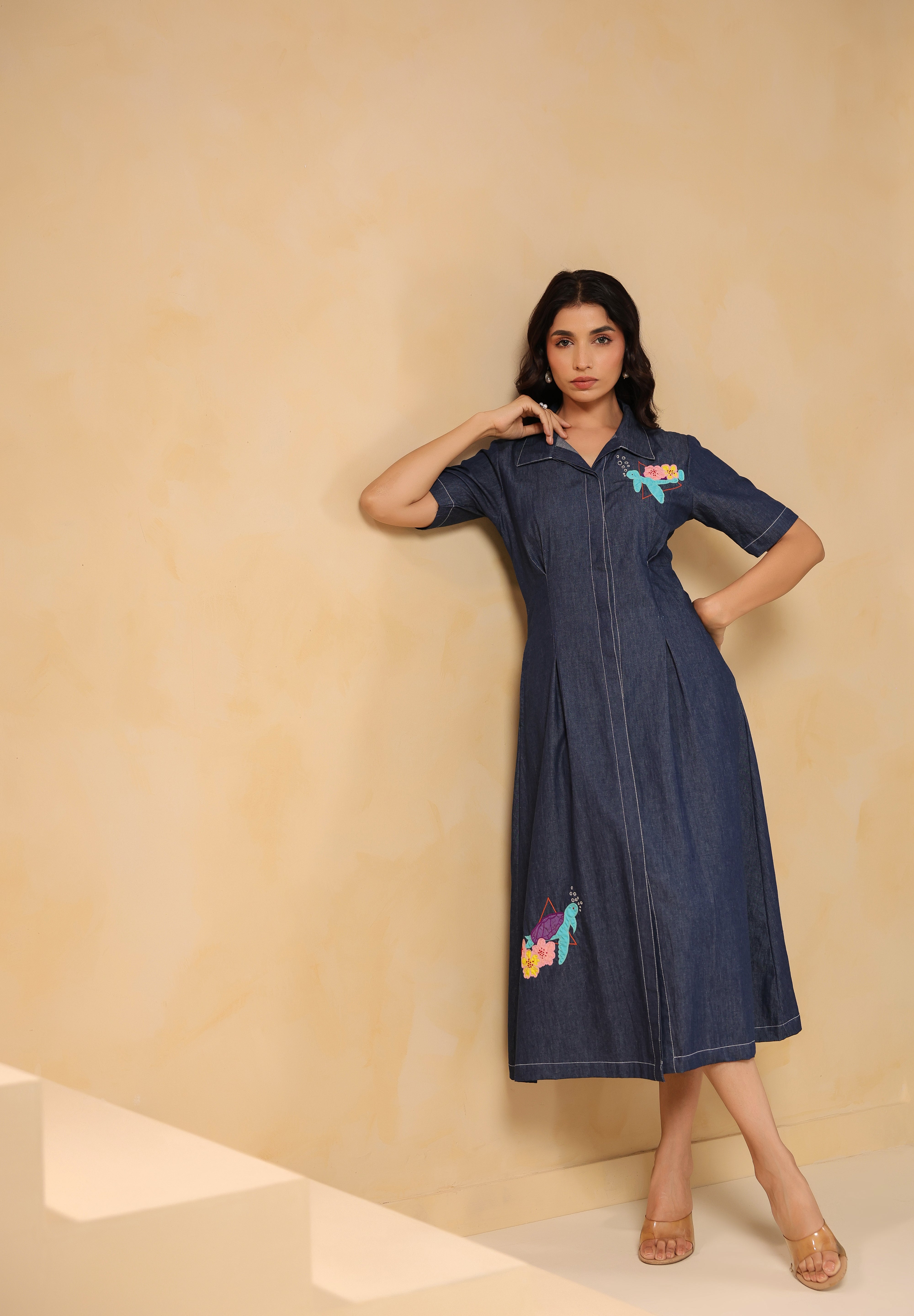 Angled view of Aqua Prism Midi Dress highlighting fitted waist and flowy hemline