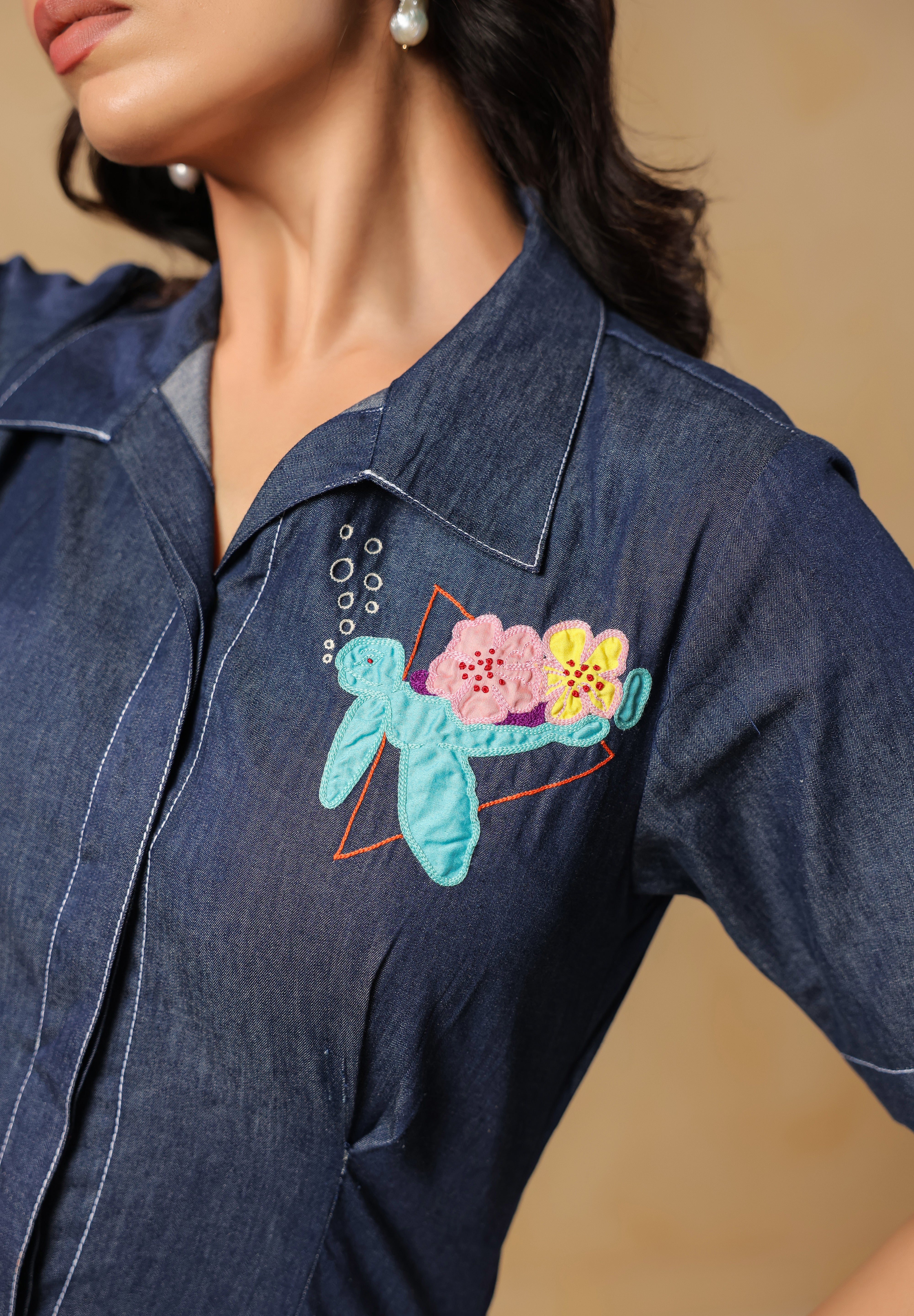 Close-up embroidery shot of turtle, florals, and bubbles on denim Aqua Prism Midi Dress