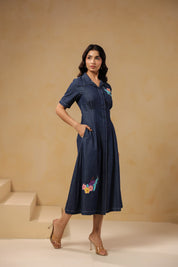 Detailed embroidery of turtle and flowers on lower skirt of Aqua Prism Midi Dress