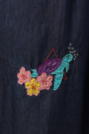 Detailed embroidery of turtle and flowers on lower skirt of Aqua Prism Midi Dress