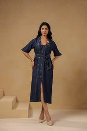 Model posing in Aviary Belted Midi Dress with button-down design