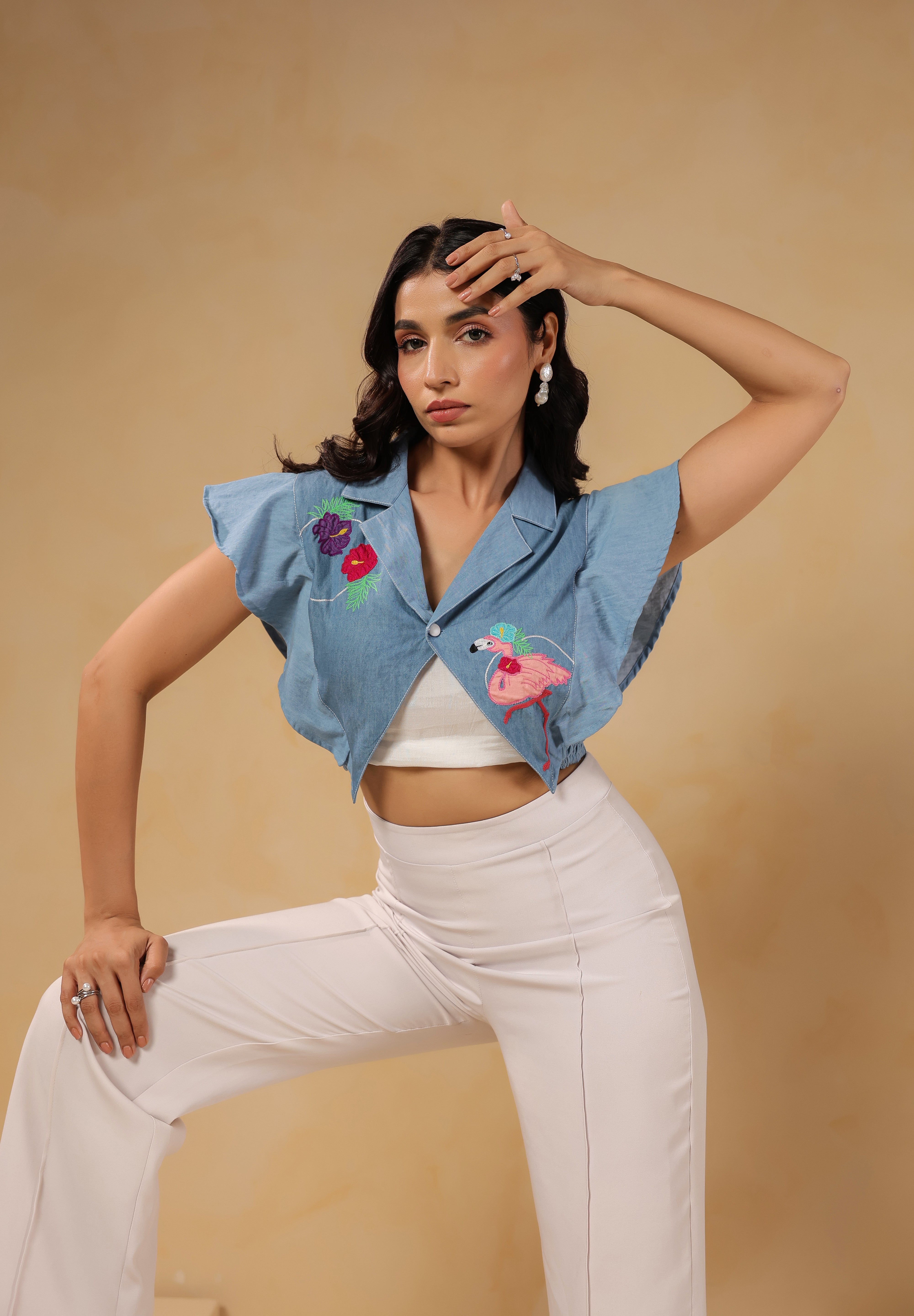 Model striking a pose in Flaminglow Crop Top with tropical detailing