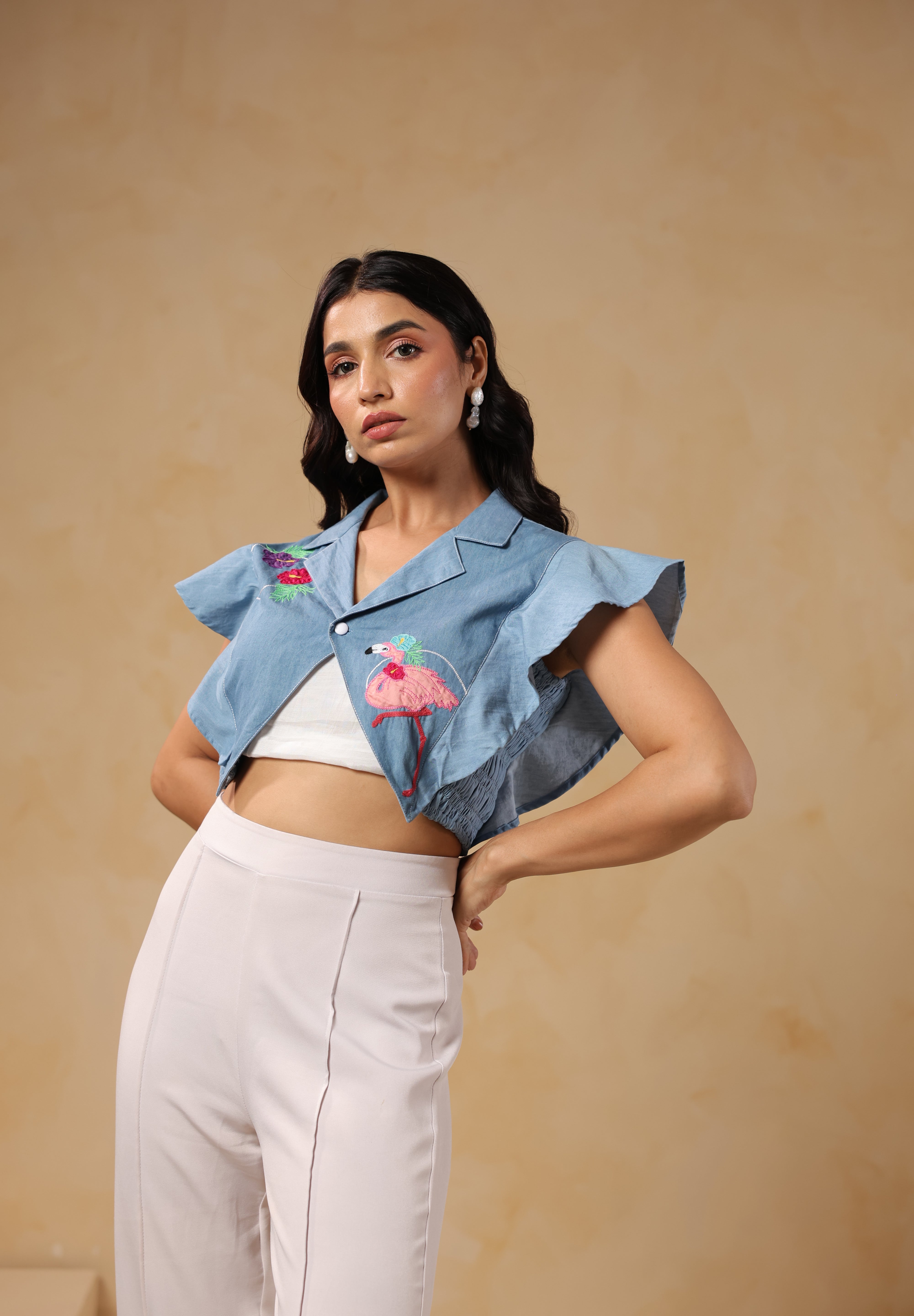 Fashion shoot pose highlighting Flaminglow Crop Top design