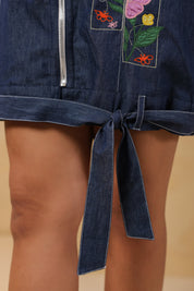 Close-up of the tie-up hem detail on the Florablock Zip Mini Dress for adjustable fit styling