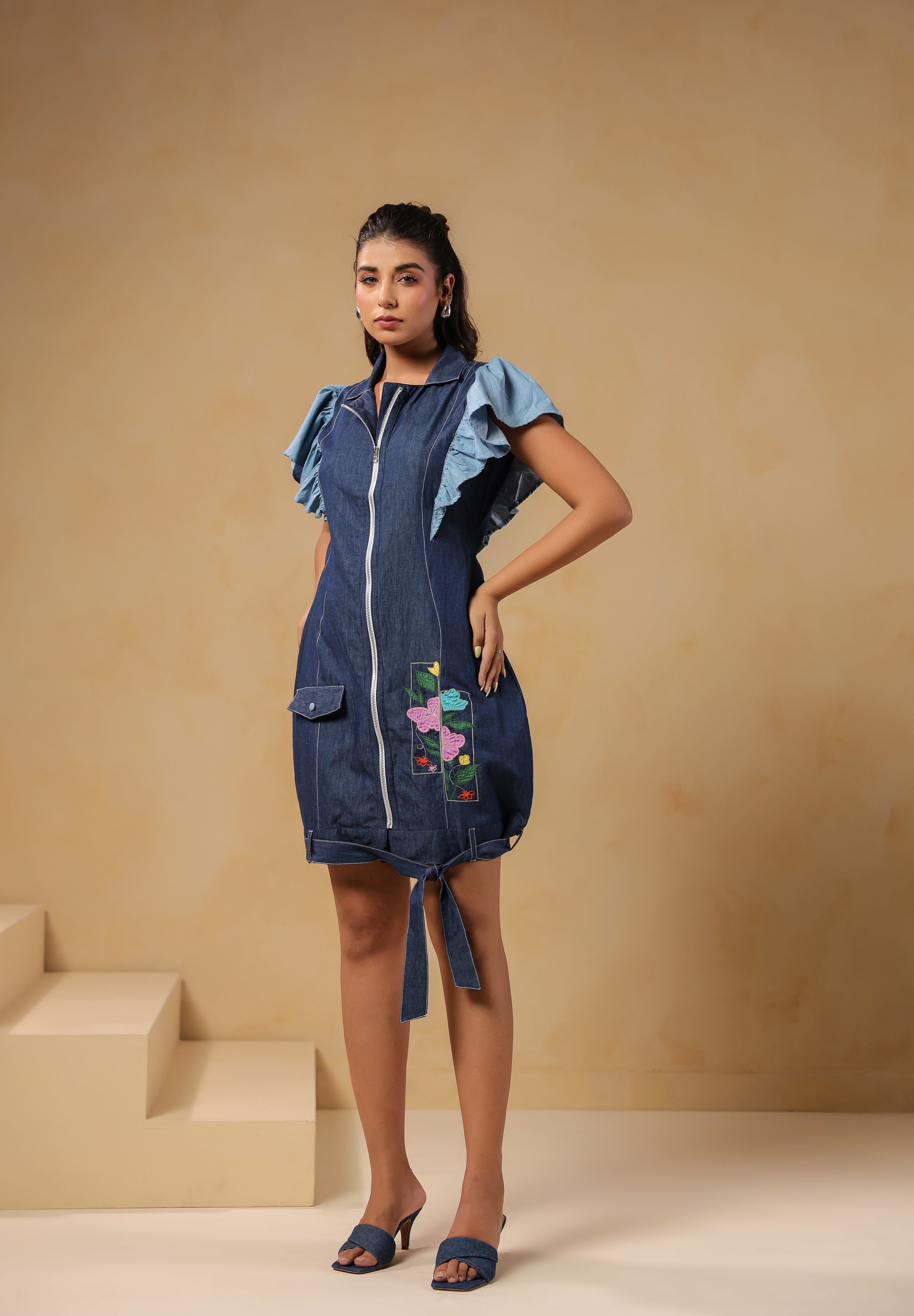 Front view of Ridah's Florablock Zip Mini Dress in denim with colorful floral embroidery and layered flutter sleeves