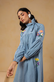 Close-up of floral embroidery and bow-tie neckline on Floraverse Denim Dress