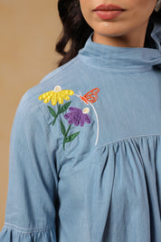 Close-up of denim texture and embroidery on Floraverse Dress