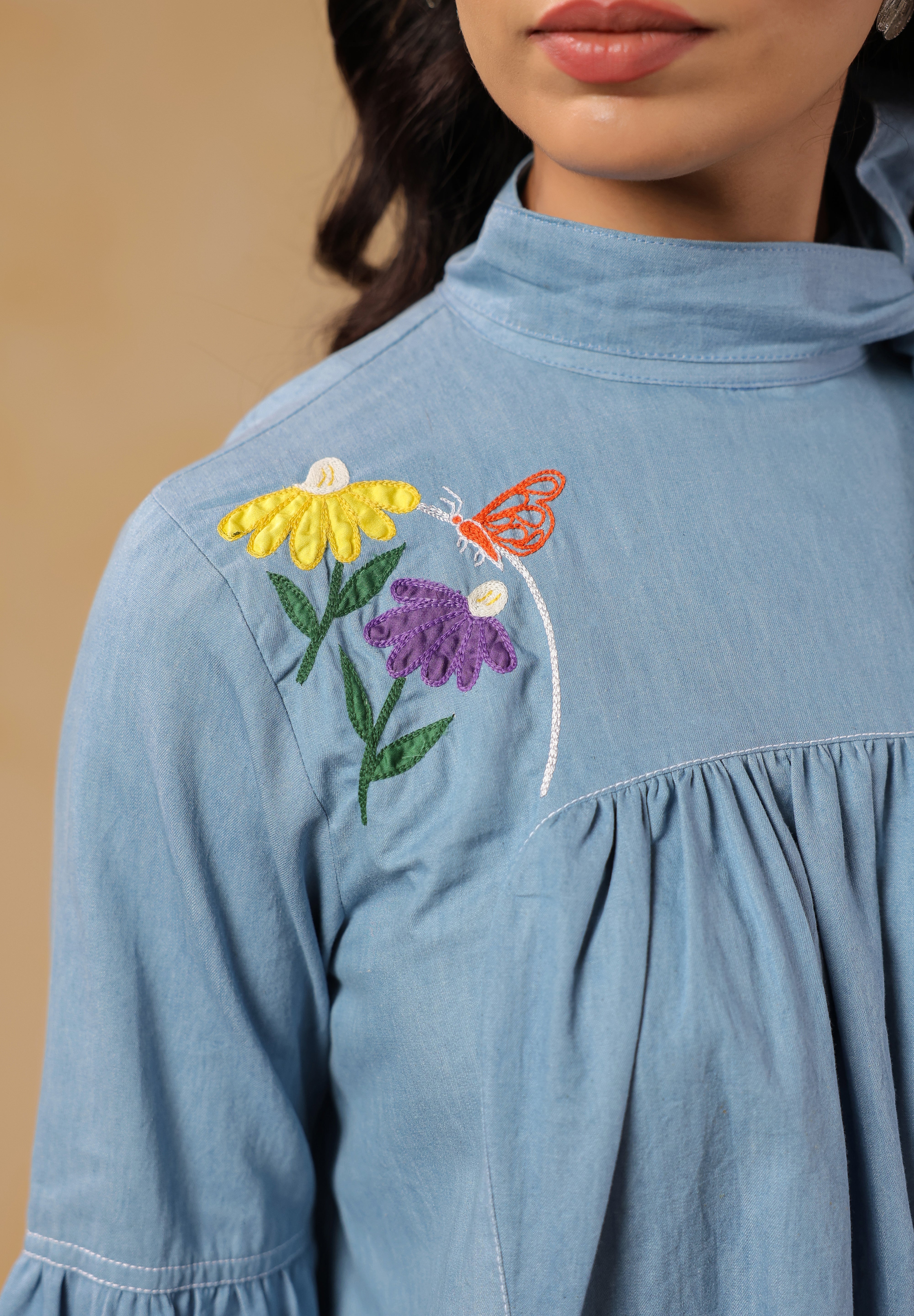 Close-up of denim texture and embroidery on Floraverse Dress