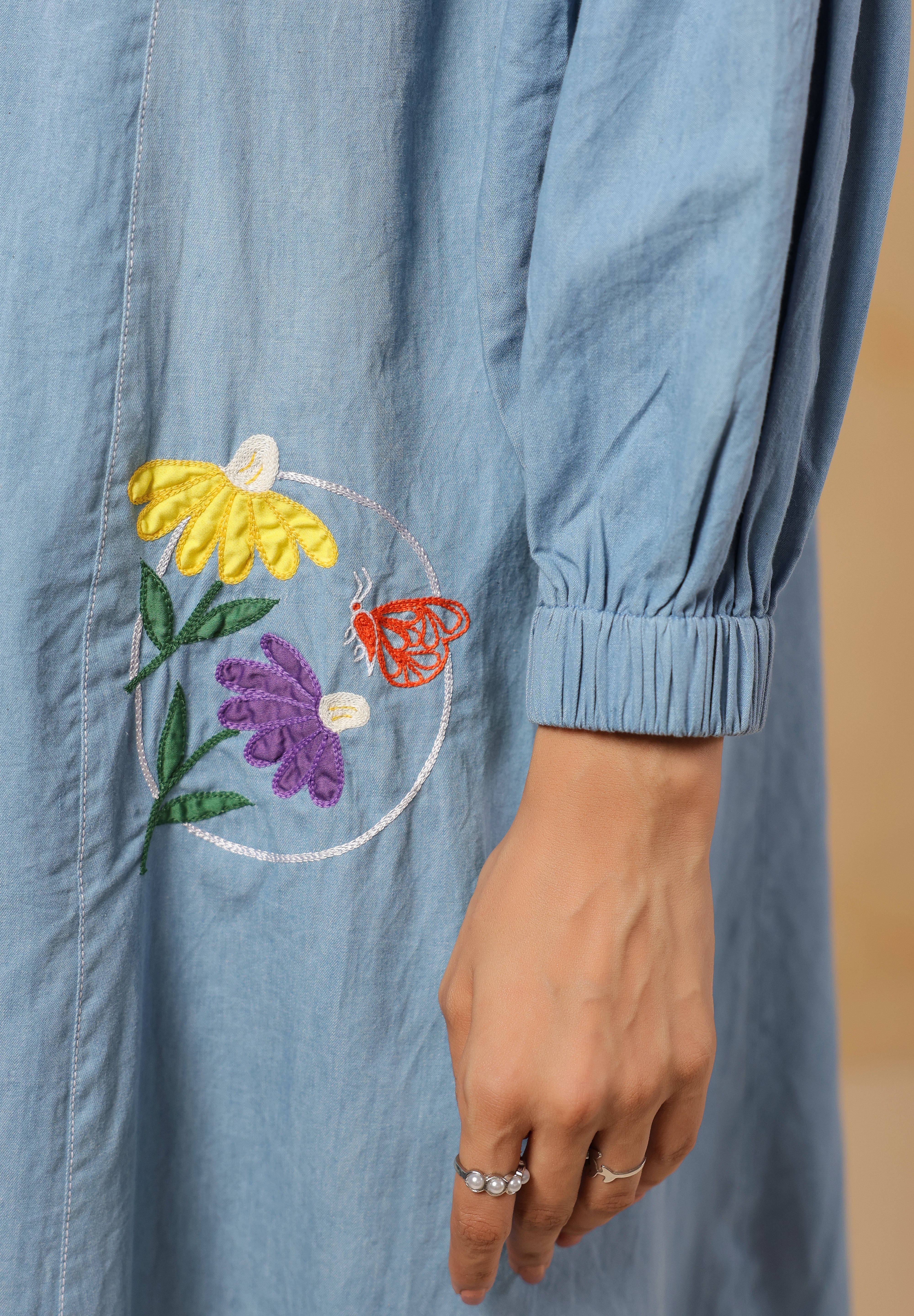 Close-up of denim texture and embroidery on Floraverse Dress