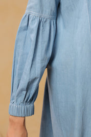 Half-body view highlighting bow-neck and yoke gathers