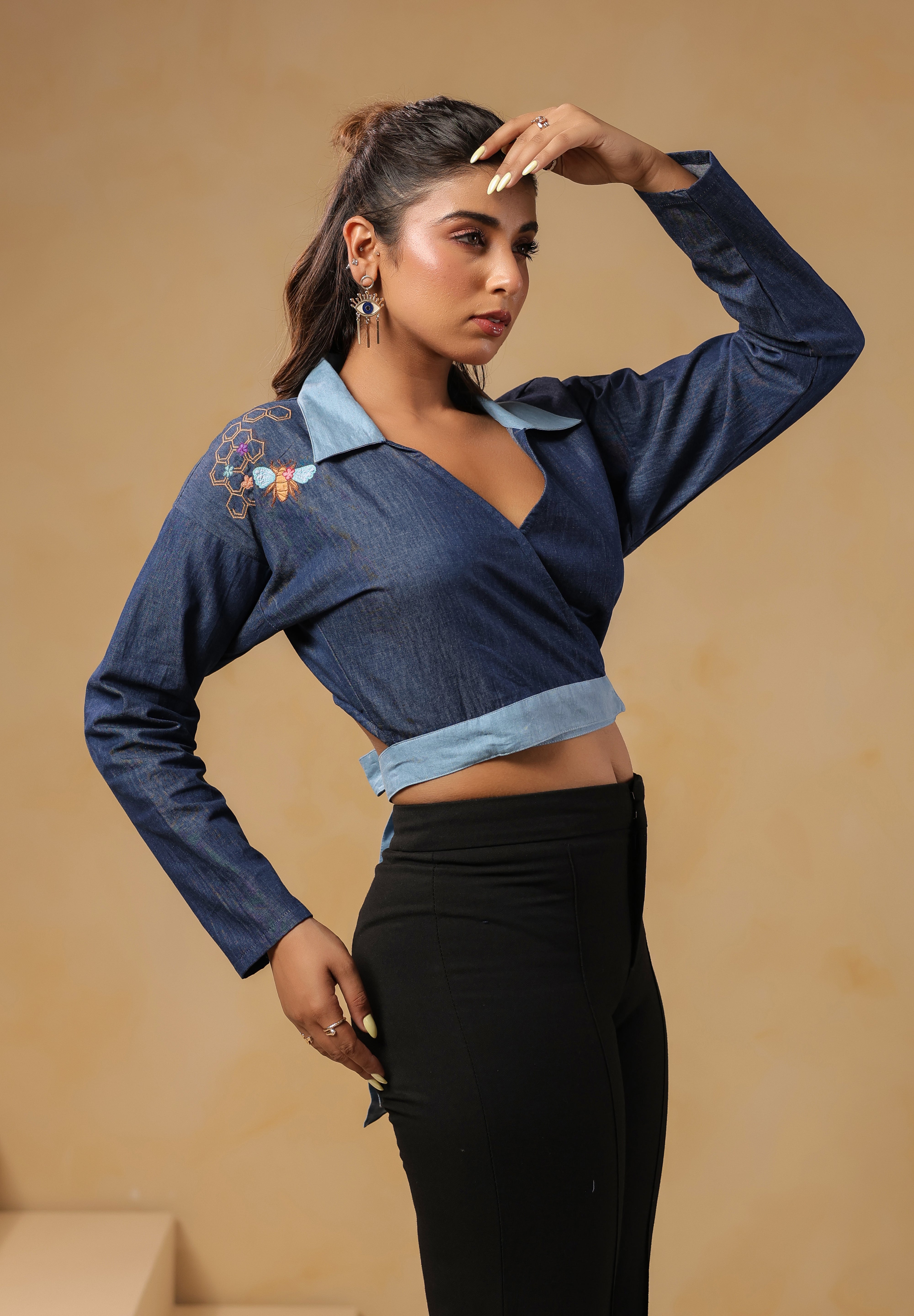 Statement look of Hexabee Wrap Top styled with black pants and geometric embroidery