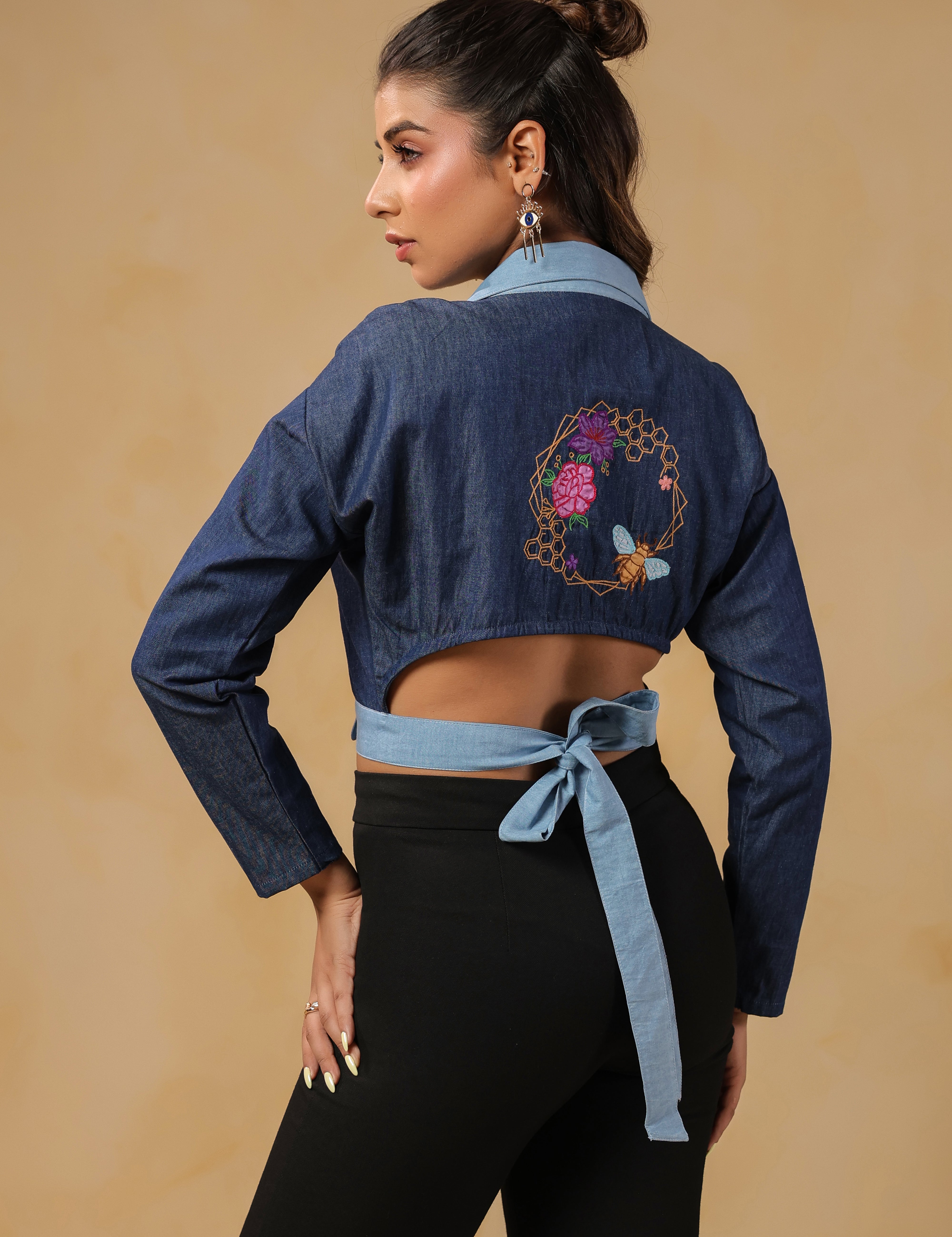 Back view of Hexabee Wrap Top showcasing honeybee embroidery and tie-up detail