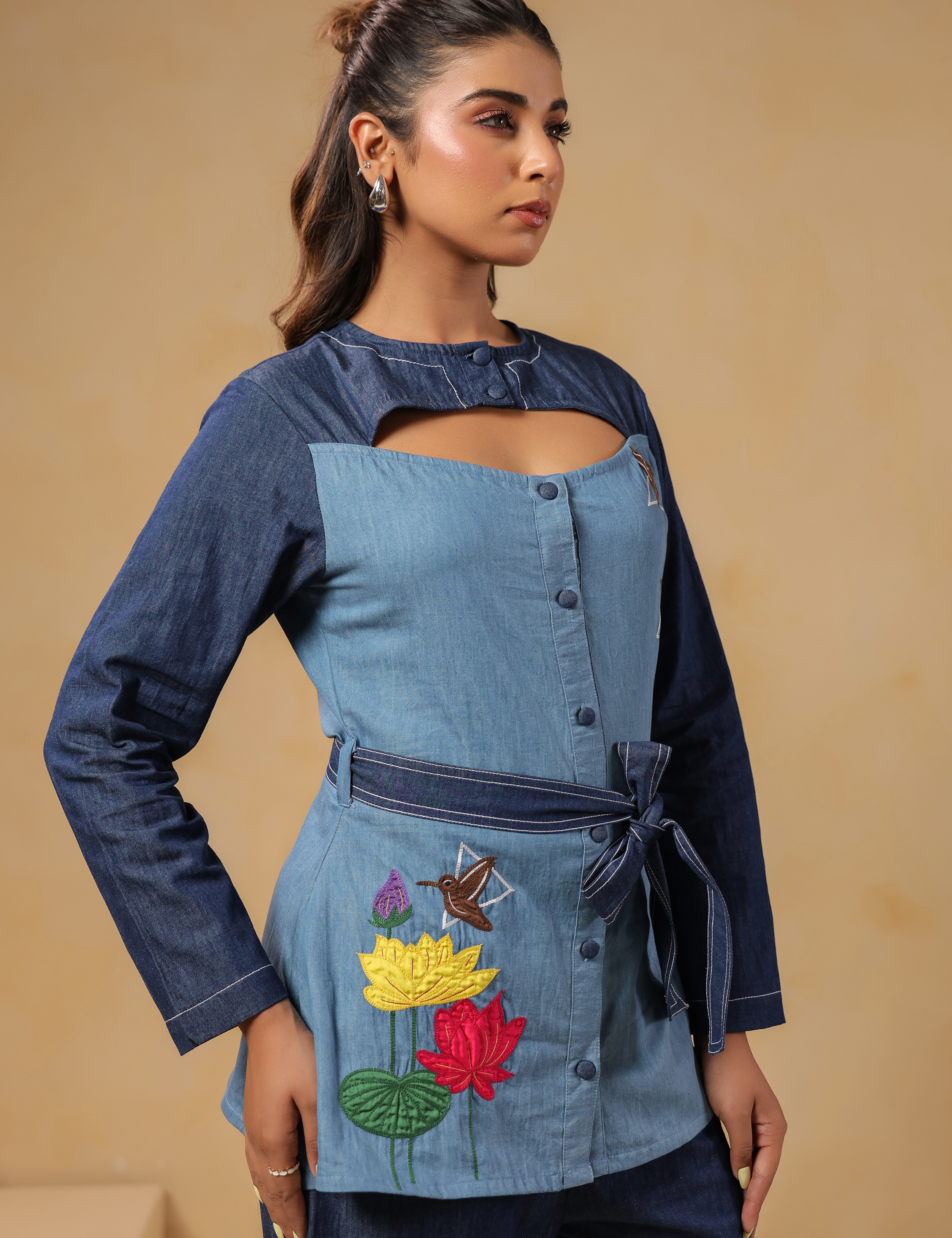 Closeup of tie-belt and handcrafted embroidery on Ridah’s Hummingbloom Coord Set — a visual balance of nature and geometry stitched in denim.