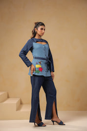 Ridah’s Hummingbloom Coord Set styled from a soft angle, showcasing abstract florals, birds, and a sculpted neckline — for women who wear art.