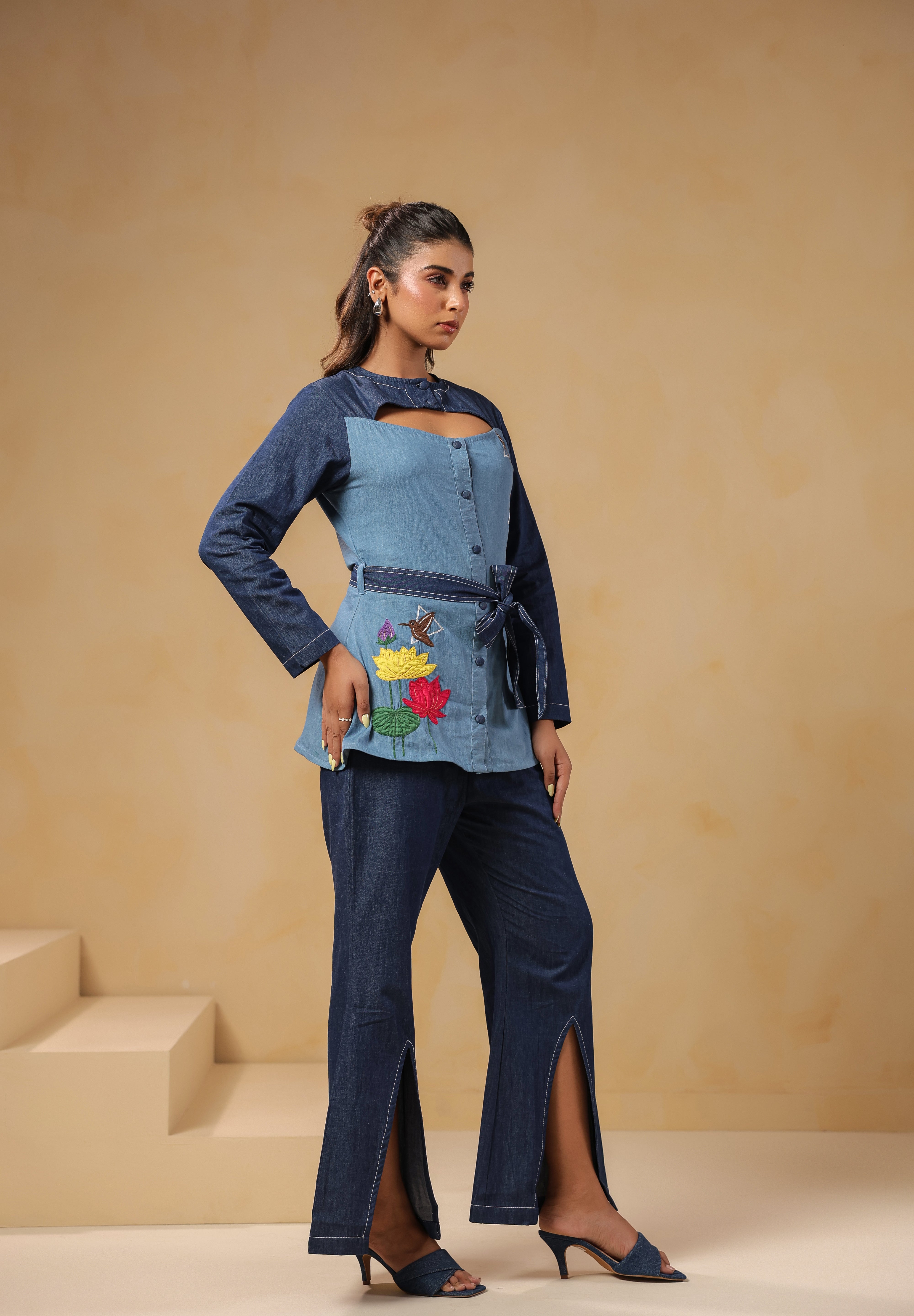 Ridah’s Hummingbloom Coord Set styled from a soft angle, showcasing abstract florals, birds, and a sculpted neckline — for women who wear art.