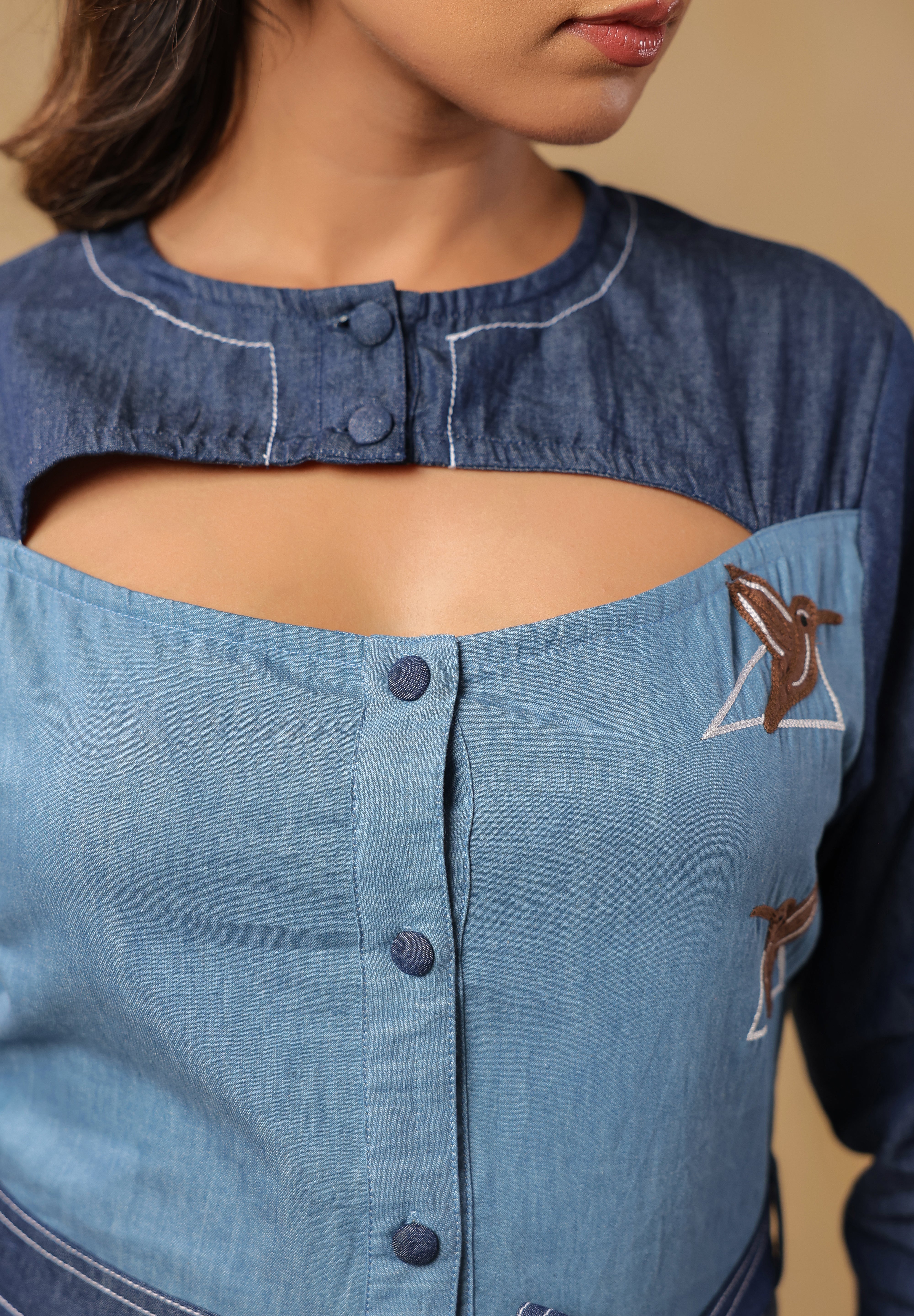 Hummingbird embroidery framed in geometric lines on Ridah’s Hummingbloom top — symbolic of motion, freedom, and modern femininity.