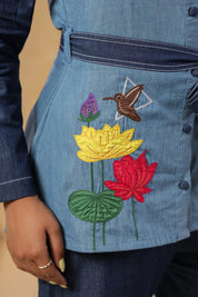 Detailed shot of blooming lotus embroidery with hummingbird motif on breathable denim — highlighting Ridah's celebration of flora in the Natureverse collection.
