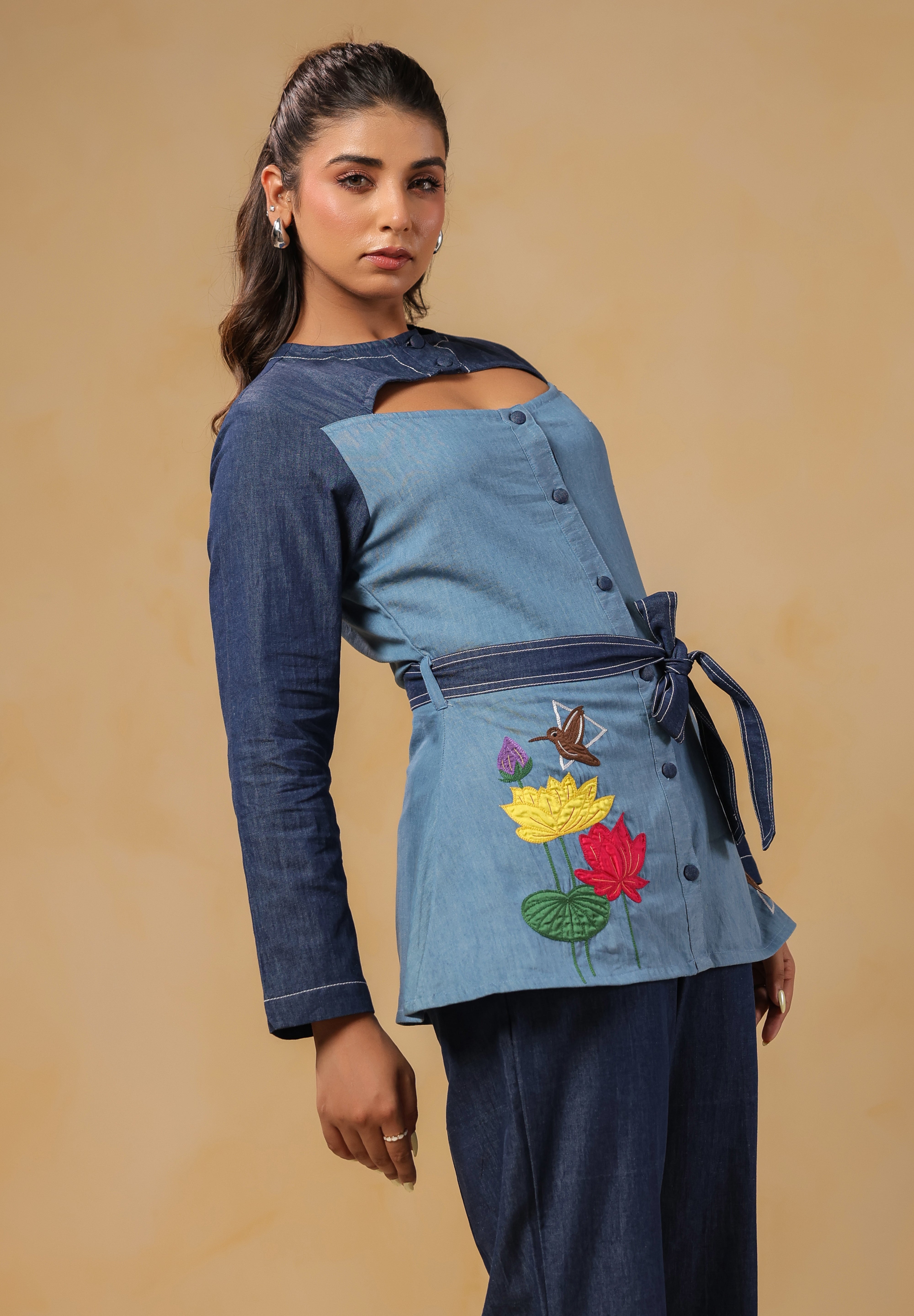 Zoomed view of structured neckline and bold cutout detail on Ridah's denim top — adding edge to elegance in the Hummingbloom Coord Set.