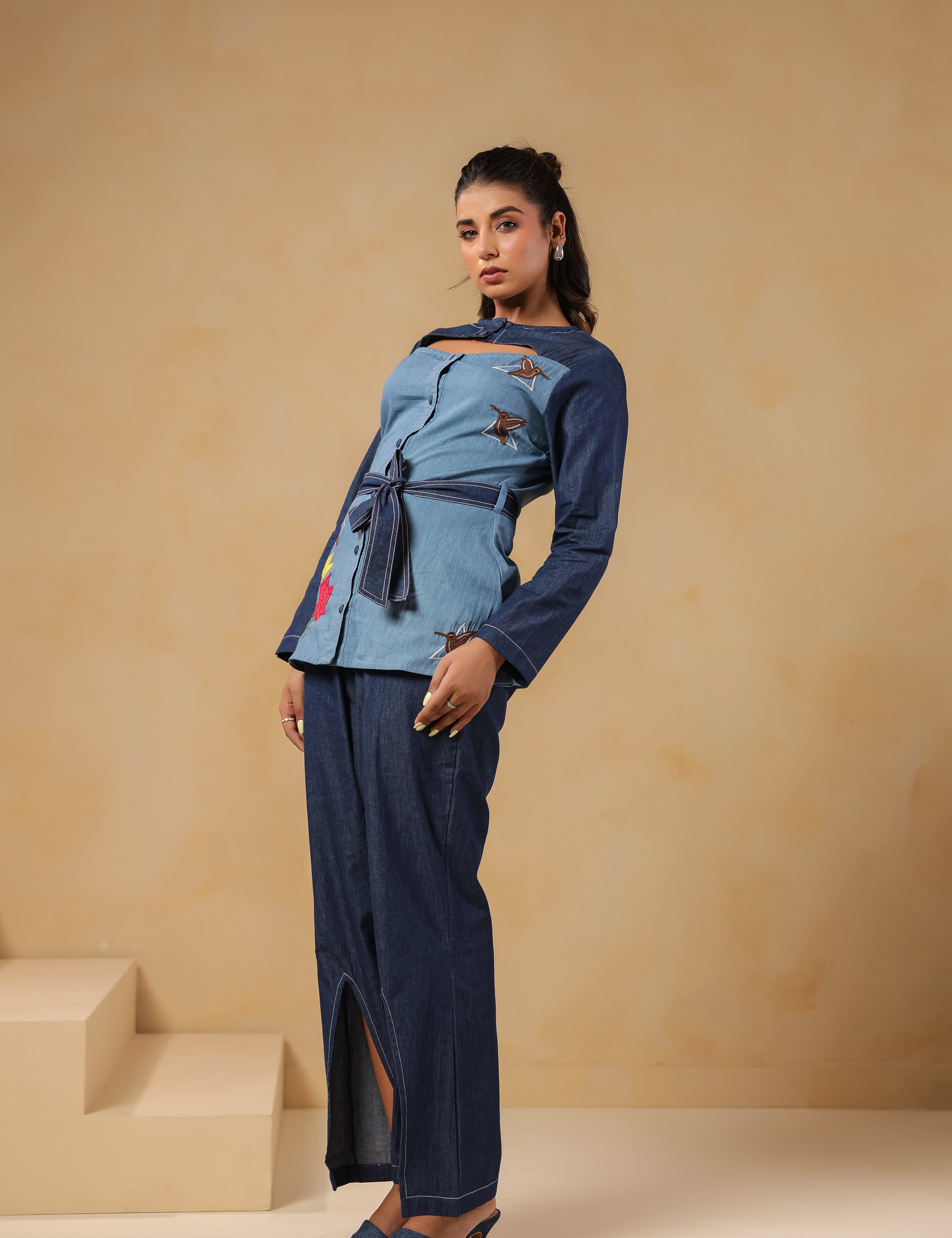 Side pose highlighting Hummingbloom Coord Set's front slit flared pants and embroidered denim top — where comfort meets couture in Ridah’s nature-inspired line.