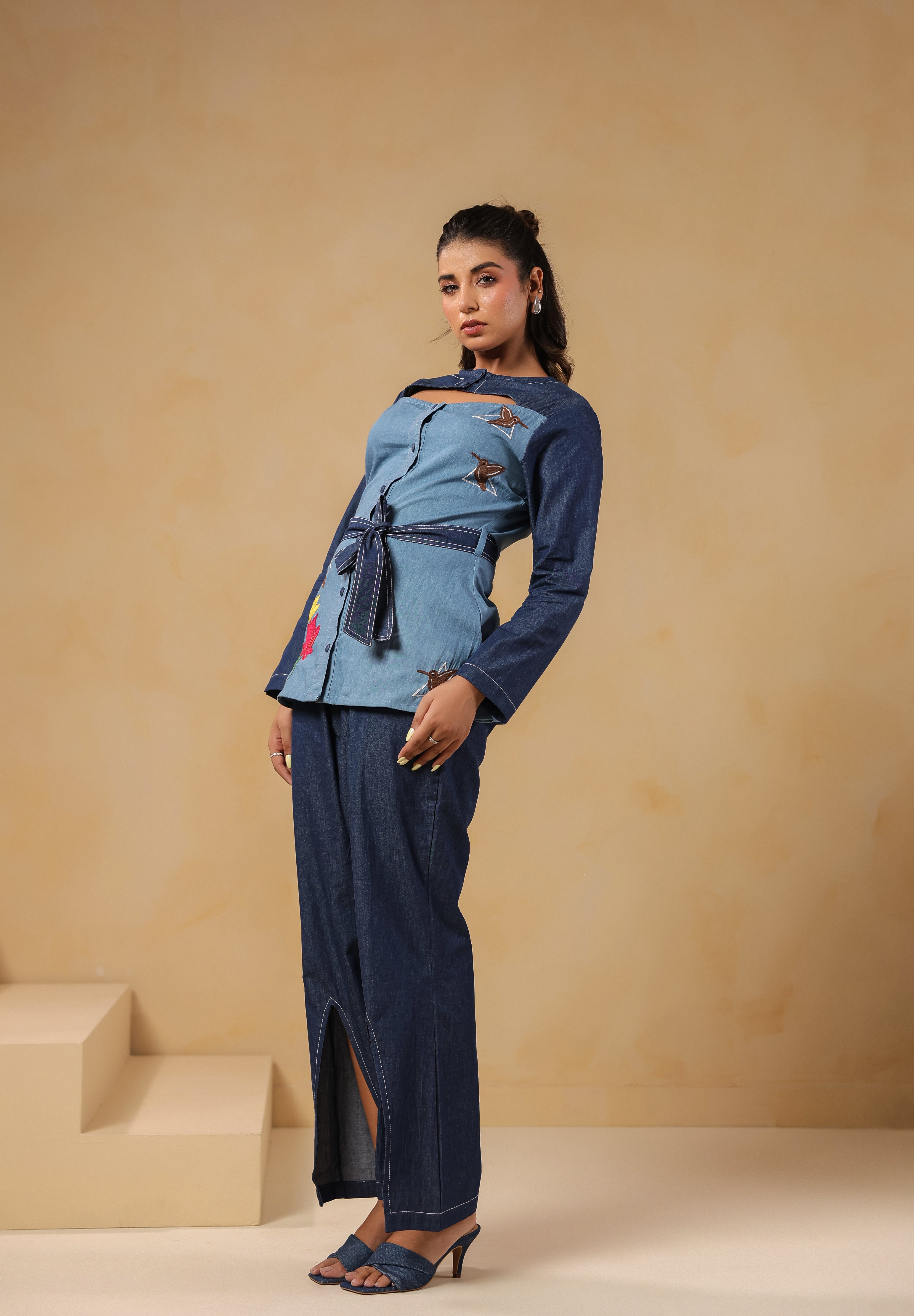 Side pose highlighting Hummingbloom Coord Set's front slit flared pants and embroidered denim top — where comfort meets couture in Ridah’s nature-inspired line.