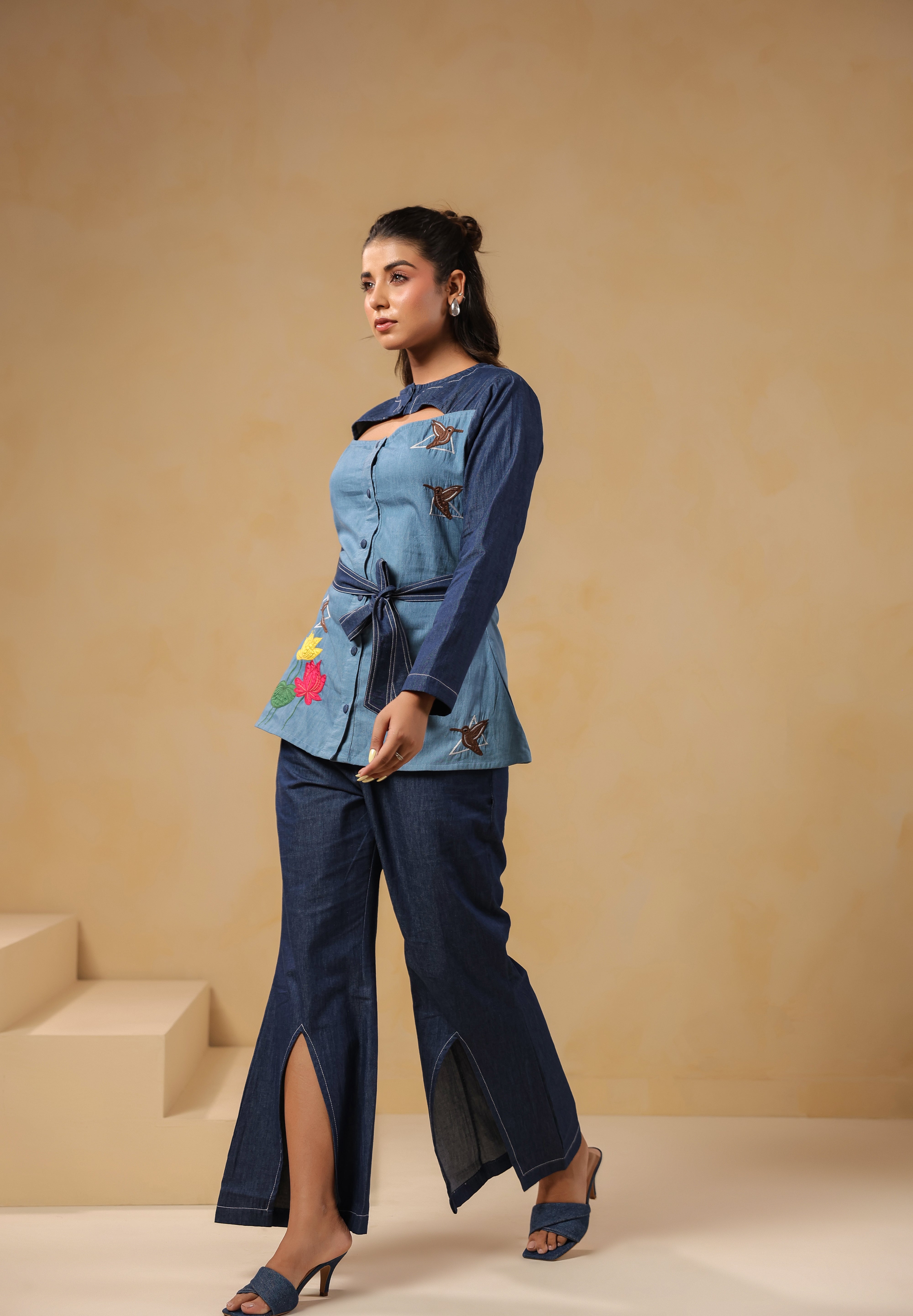 Side pose highlighting Hummingbloom Coord Set's front slit flared pants and embroidered denim top — where comfort meets couture in Ridah’s nature-inspired line.