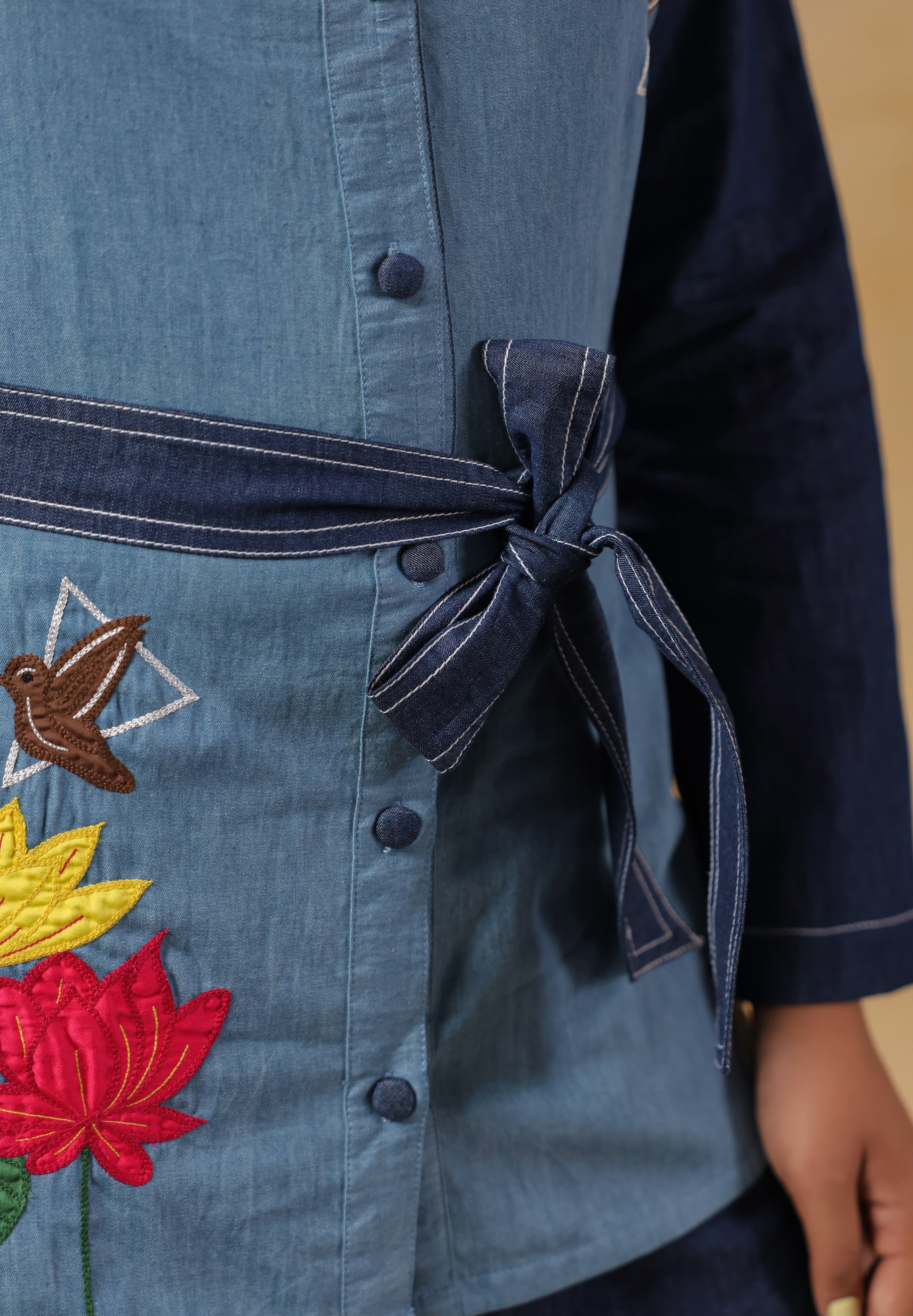 Signature Ridah tilt showcasing the Hummingbloom Coord Set’s fitted silhouette, vibrant embroidery, and versatility for expressive everyday style.
