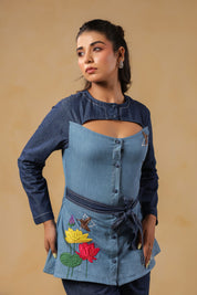 Signature Ridah tilt showcasing the Hummingbloom Shirt's fitted silhouette, vibrant embroidery, and versatility for expressive everyday style.