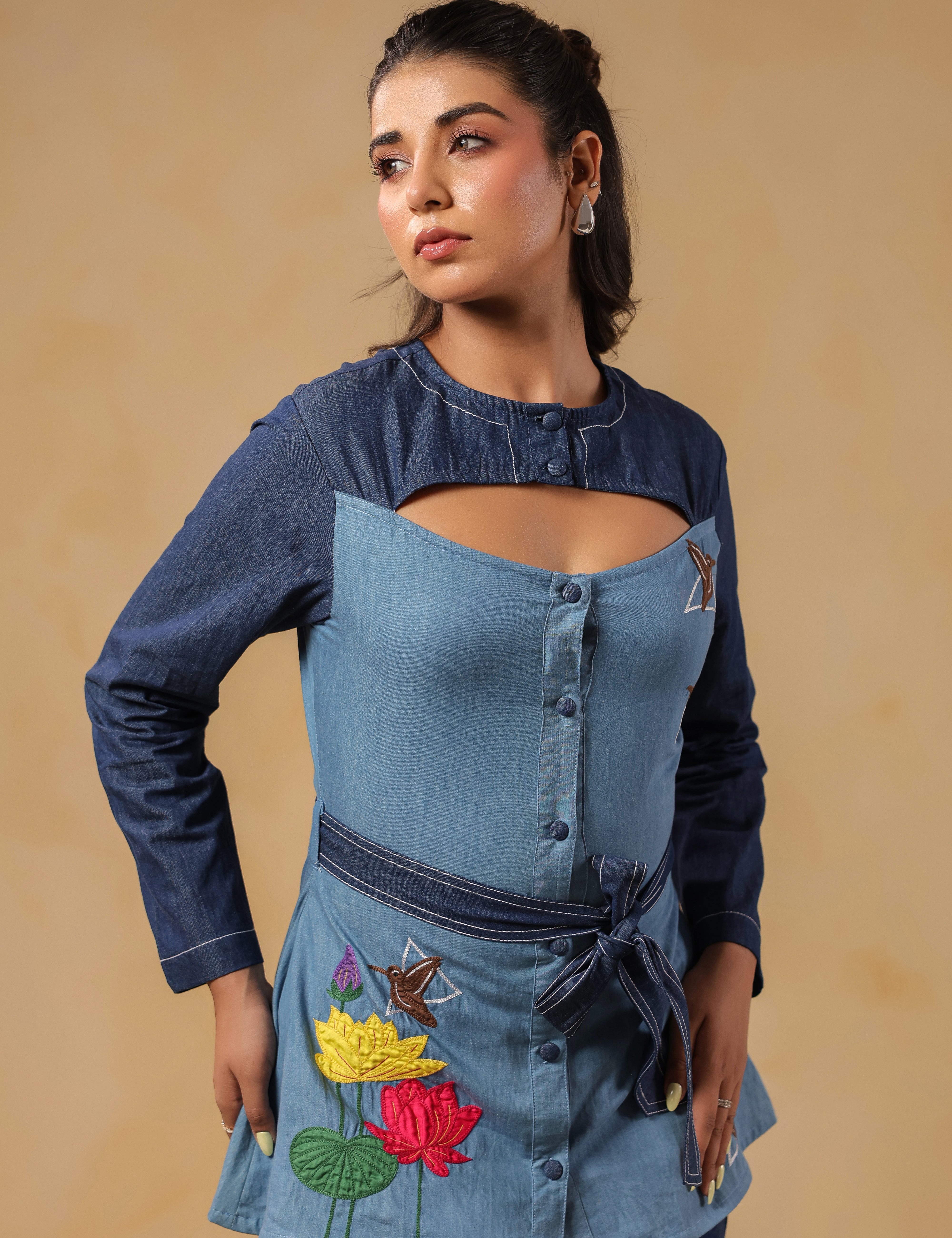 Signature Ridah tilt showcasing the Hummingbloom Shirt's fitted silhouette, vibrant embroidery, and versatility for expressive everyday style.