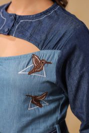 Hummingbird embroidery framed in geometric lines on Ridah’s Hummingbloom top — symbolic of motion, freedom, and modern femininity.