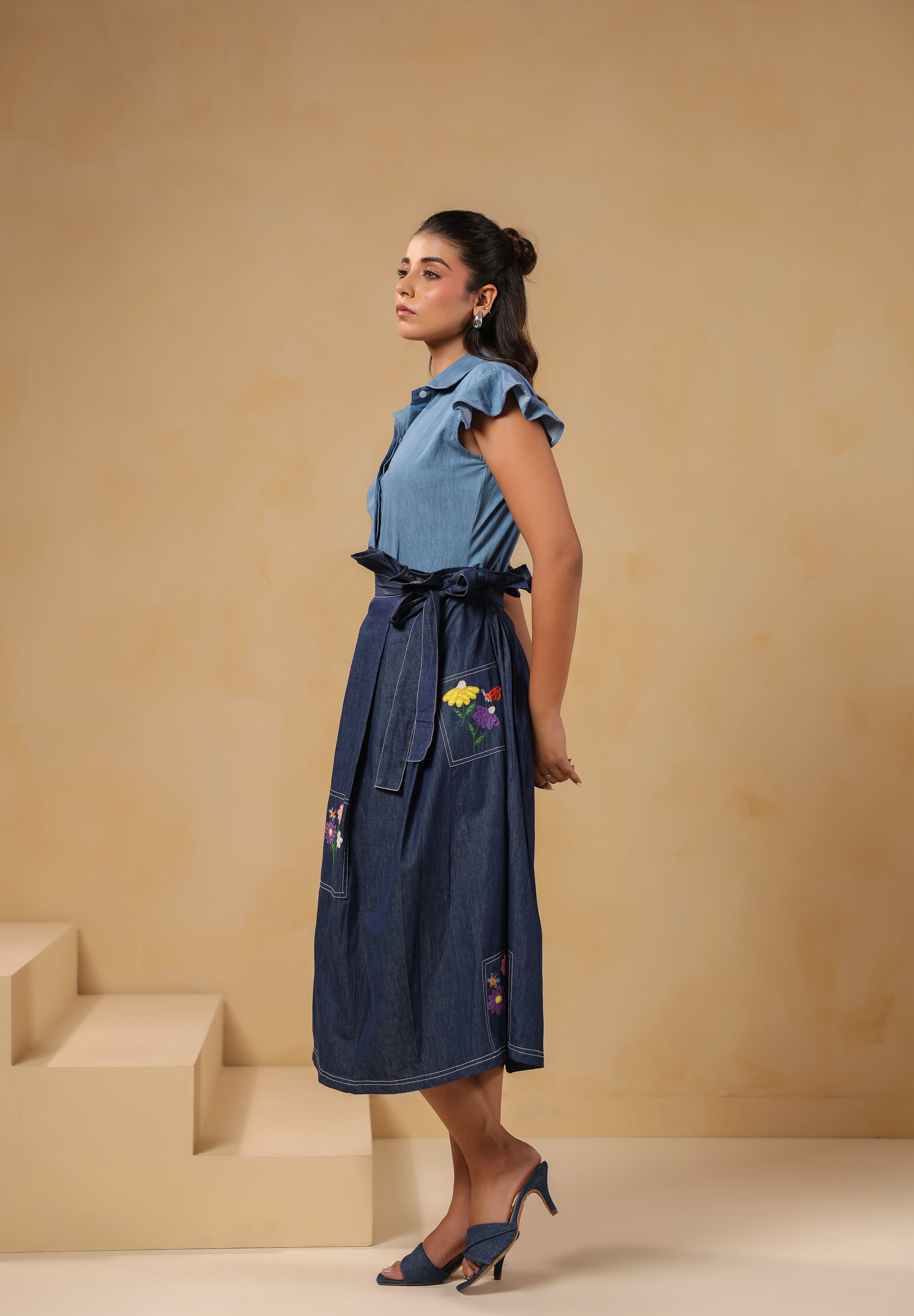 Side profile of Meadowflair Coord Set highlighting the waist-cinching tie-up belt and floral pocket detail on flared denim skirt.