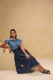 Relaxed sitting pose in Meadowflair Coord Set showing movement, hand-done embroidery and light structure — timeless denim for everyday storytelling.