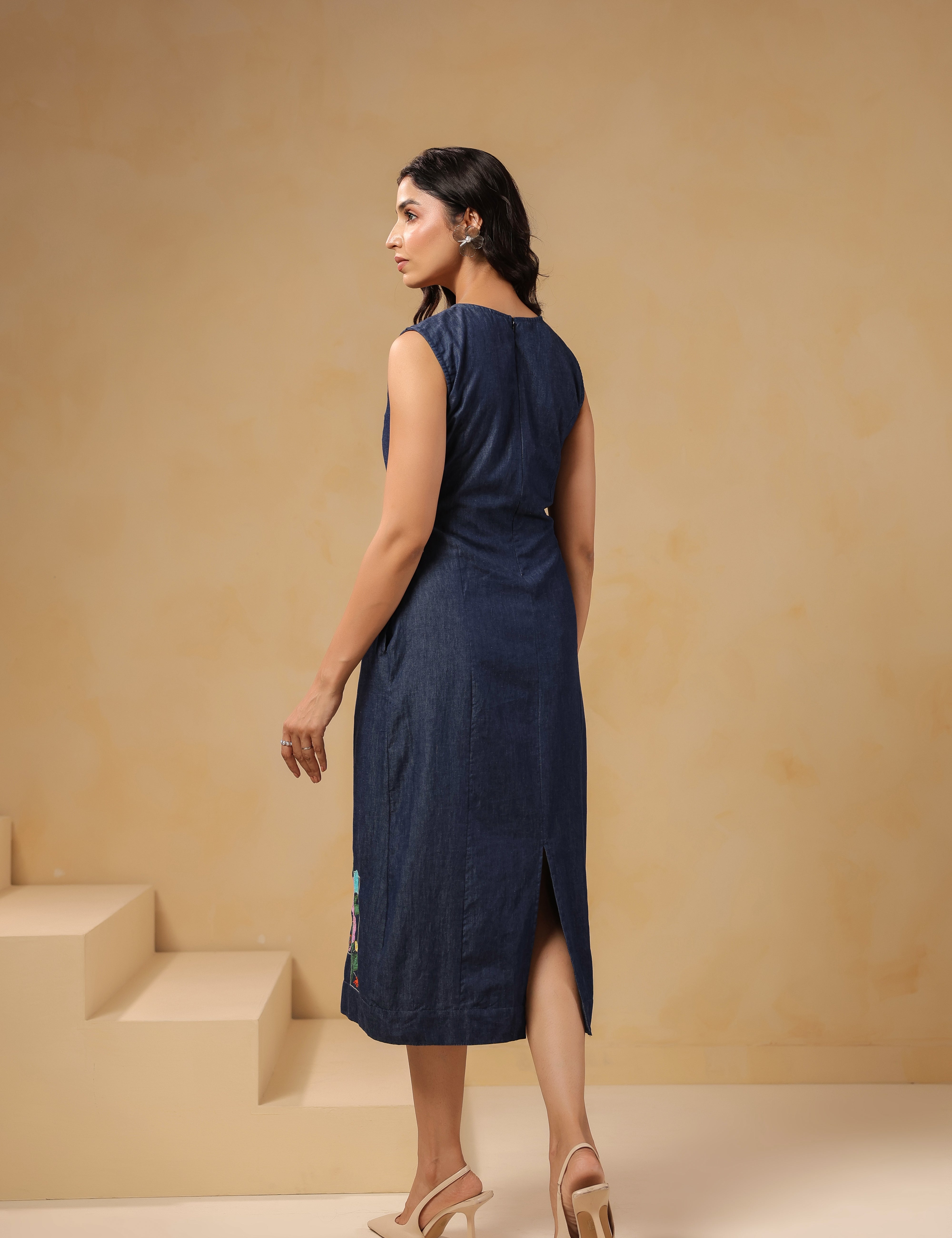 Back view of sleeveless Rectaflora Midi Dress in blue denim.