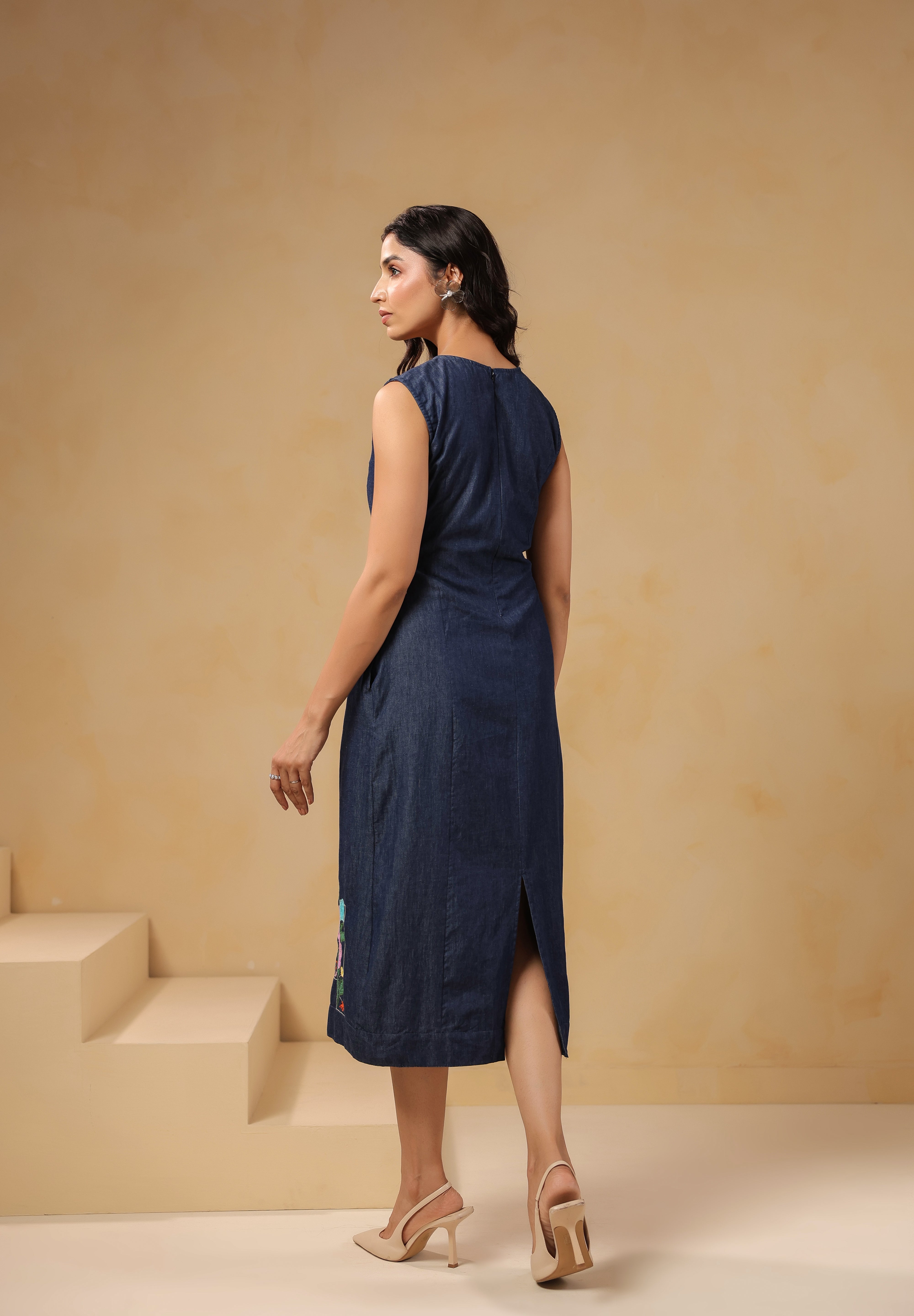 Back view of sleeveless Rectaflora Midi Dress in blue denim.