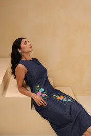 Relaxed seated pose in Rectaflora Midi Dress with embroidery panels.