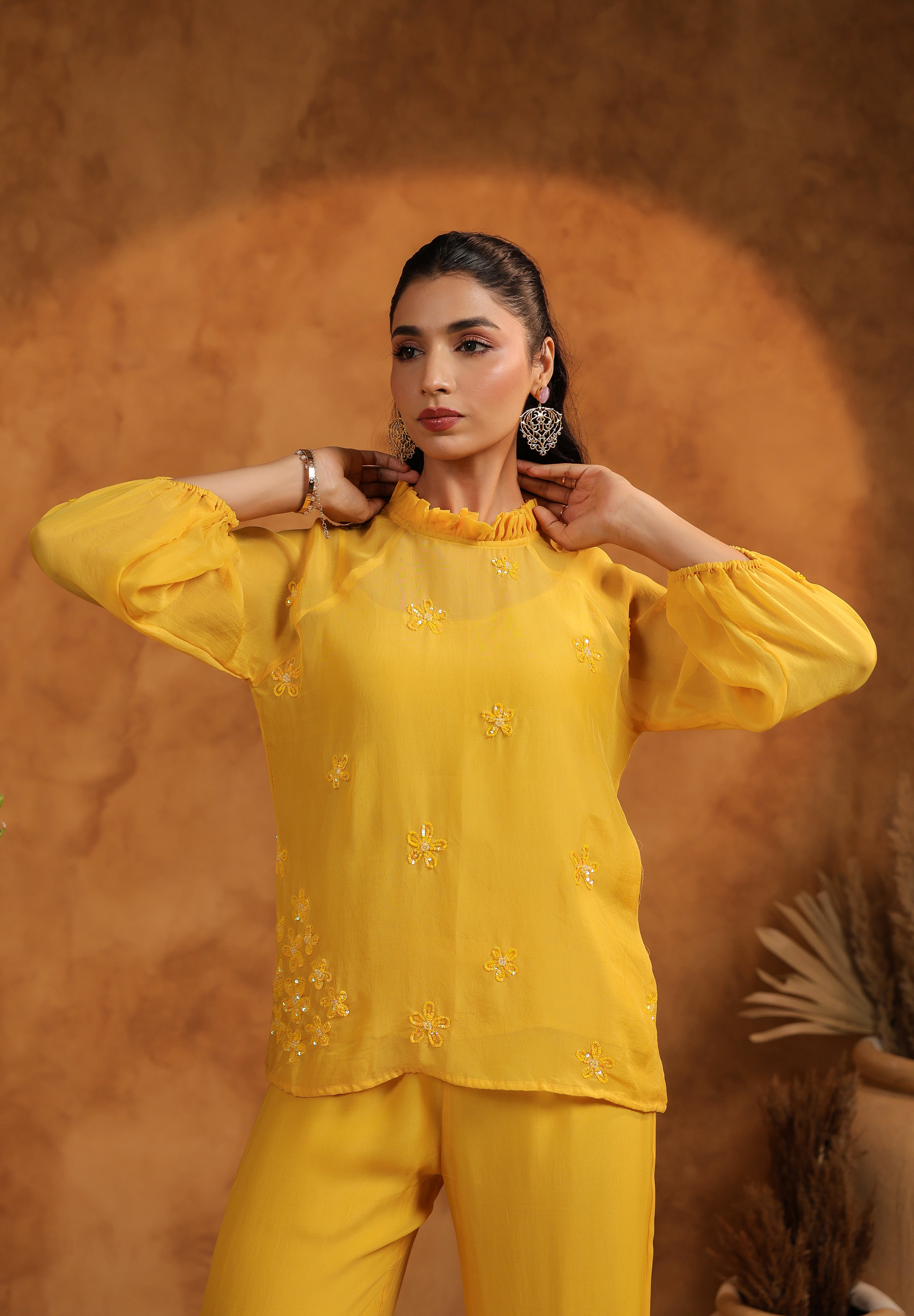 Mid-length shot capturing the glow of the model and embroidered floral panels of the Sunflare Set.