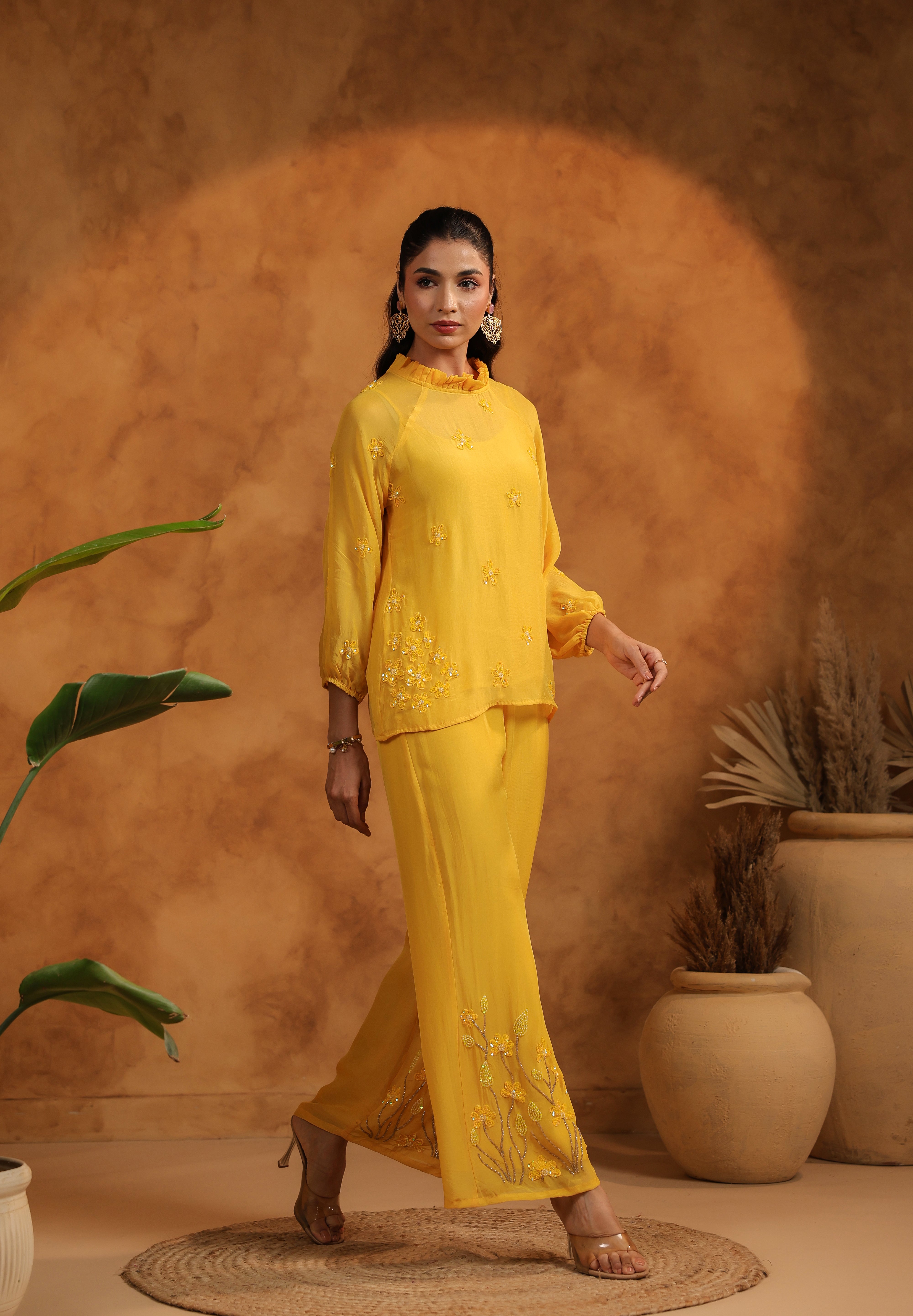 Relaxed smile with front-facing pose, emphasizing the colorful threadwork near the waistline.