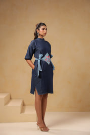Diagonal view of Tide & Ties Flamingo Dress showing tie-up waist and flamingo motif