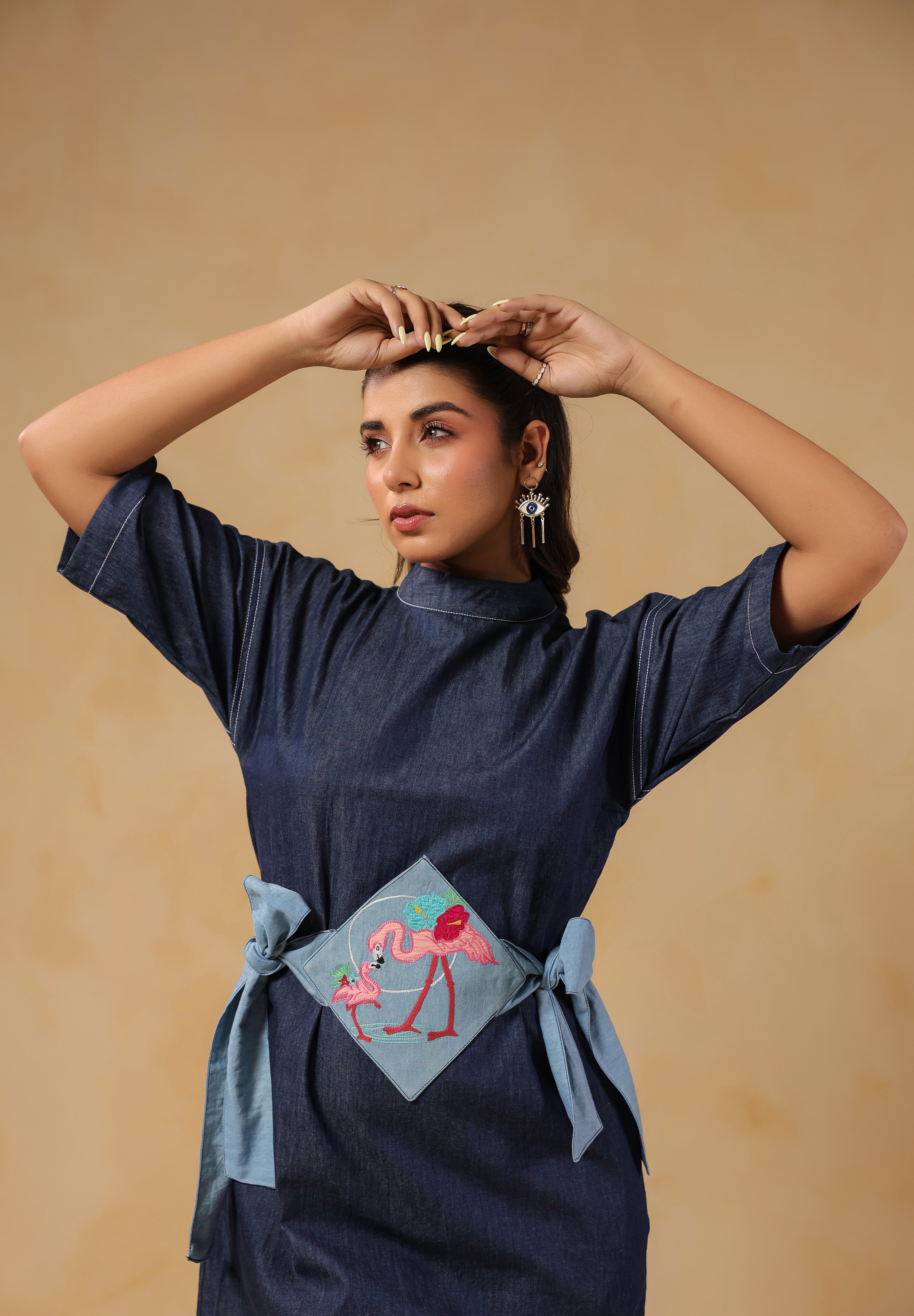 Zoomed-in embroidery of mother and baby flamingo on Tide & Ties Denim Dress