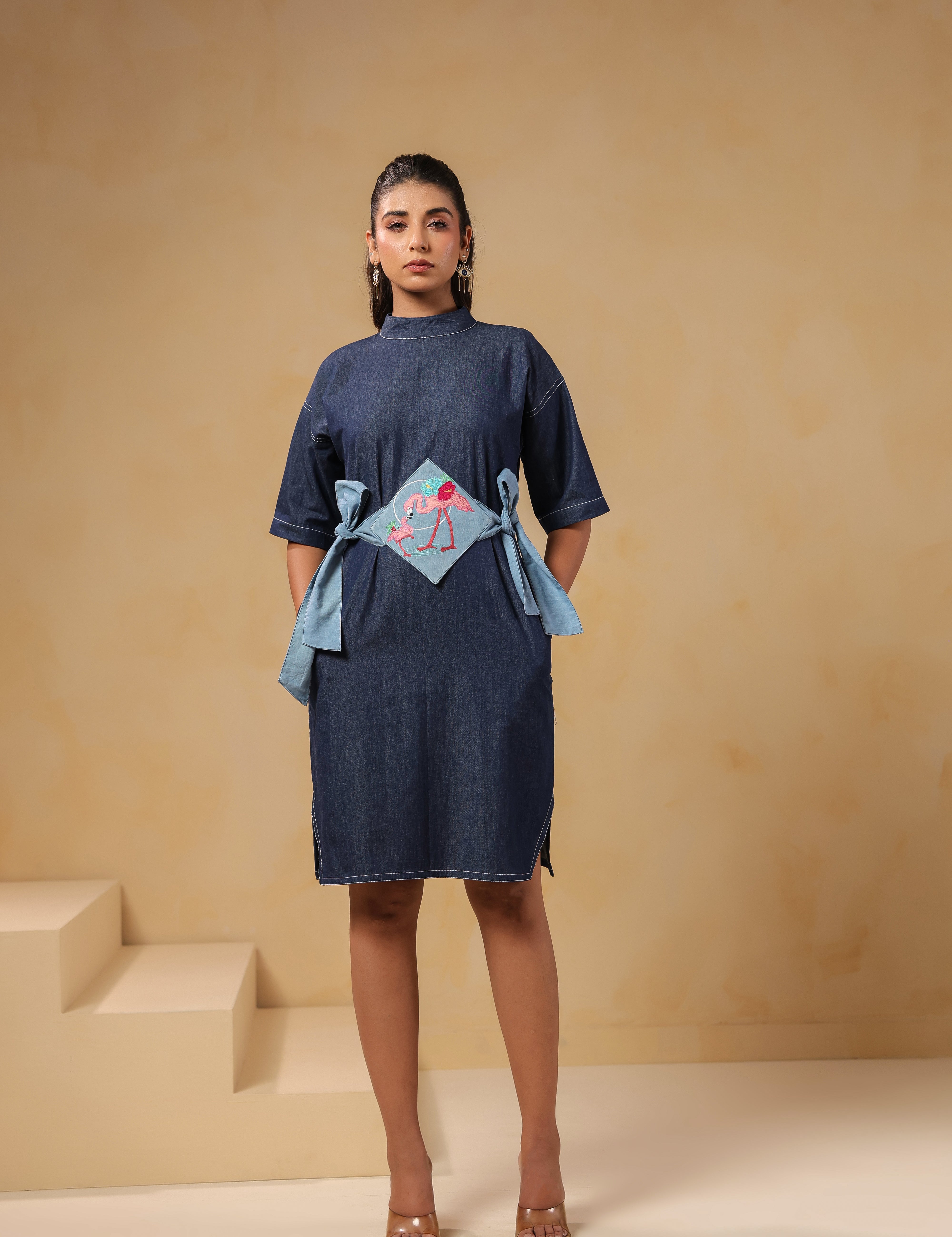 Front look of Tide & Ties Flamingo Dress featuring flamingo embroidery and denim belt ties