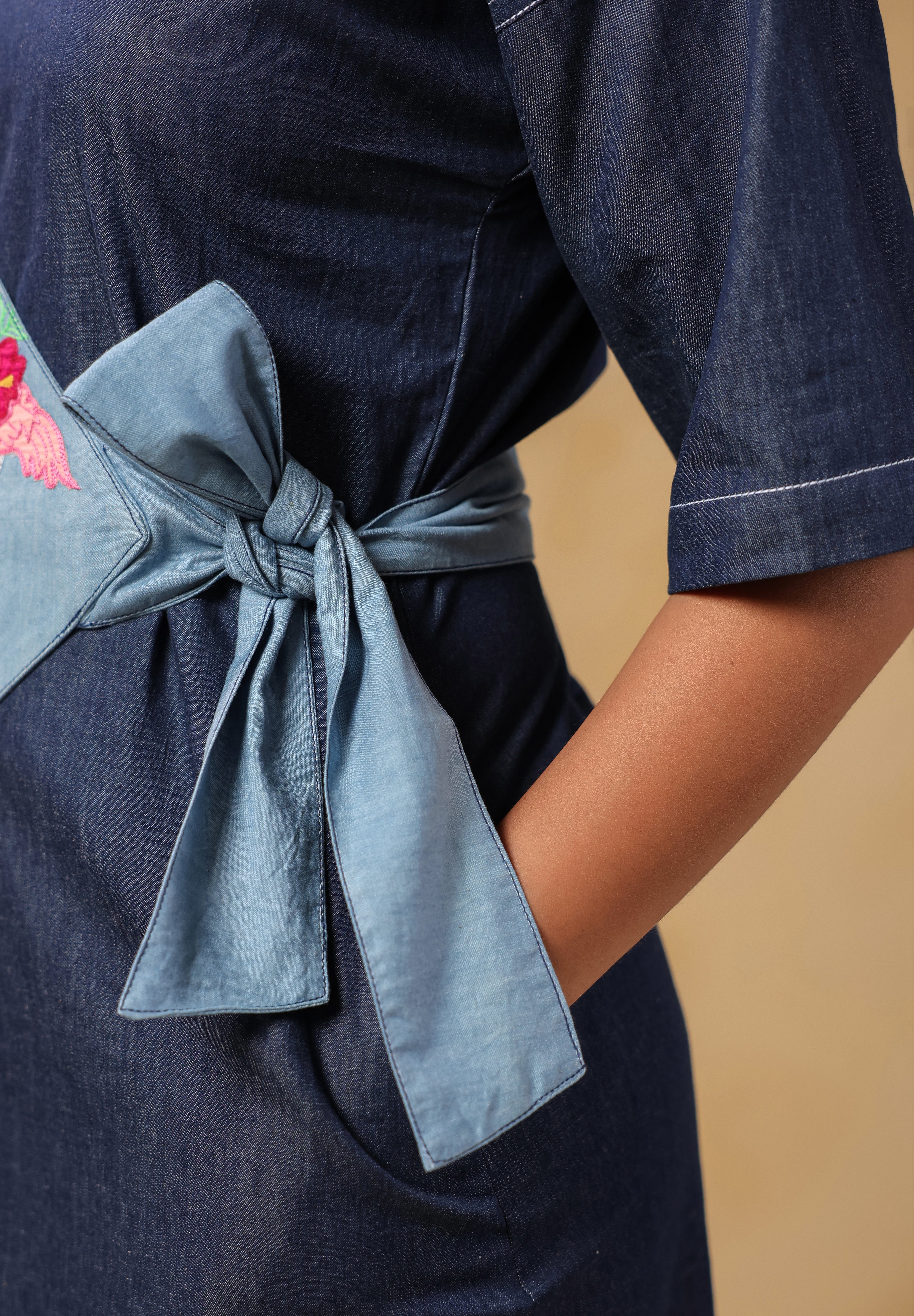 Model posing in Tide & Ties Flamingo Dress with playful embroidered flamingo design