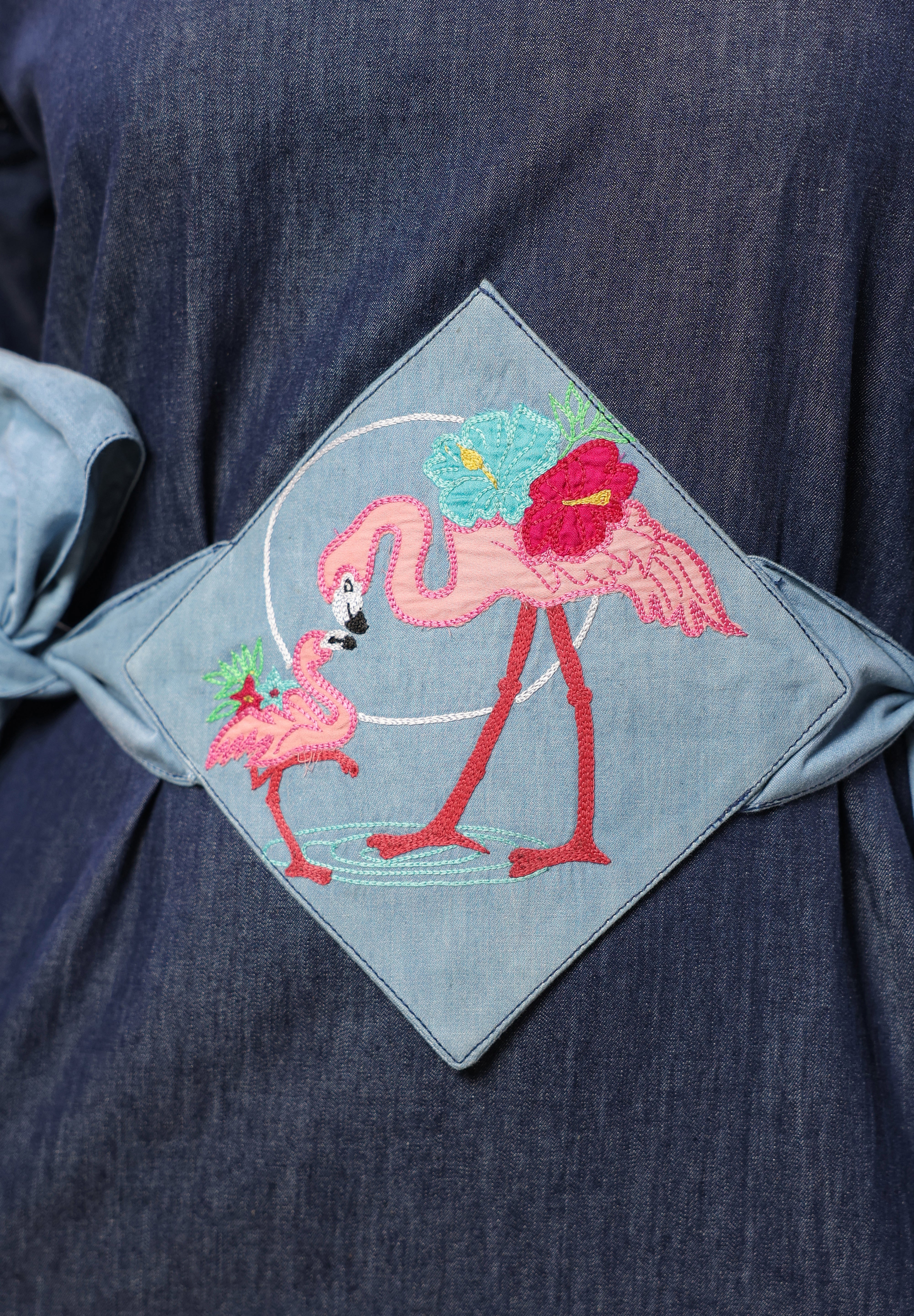 Detailed view of light denim tie belt on Tide & Ties Flamingo Dress