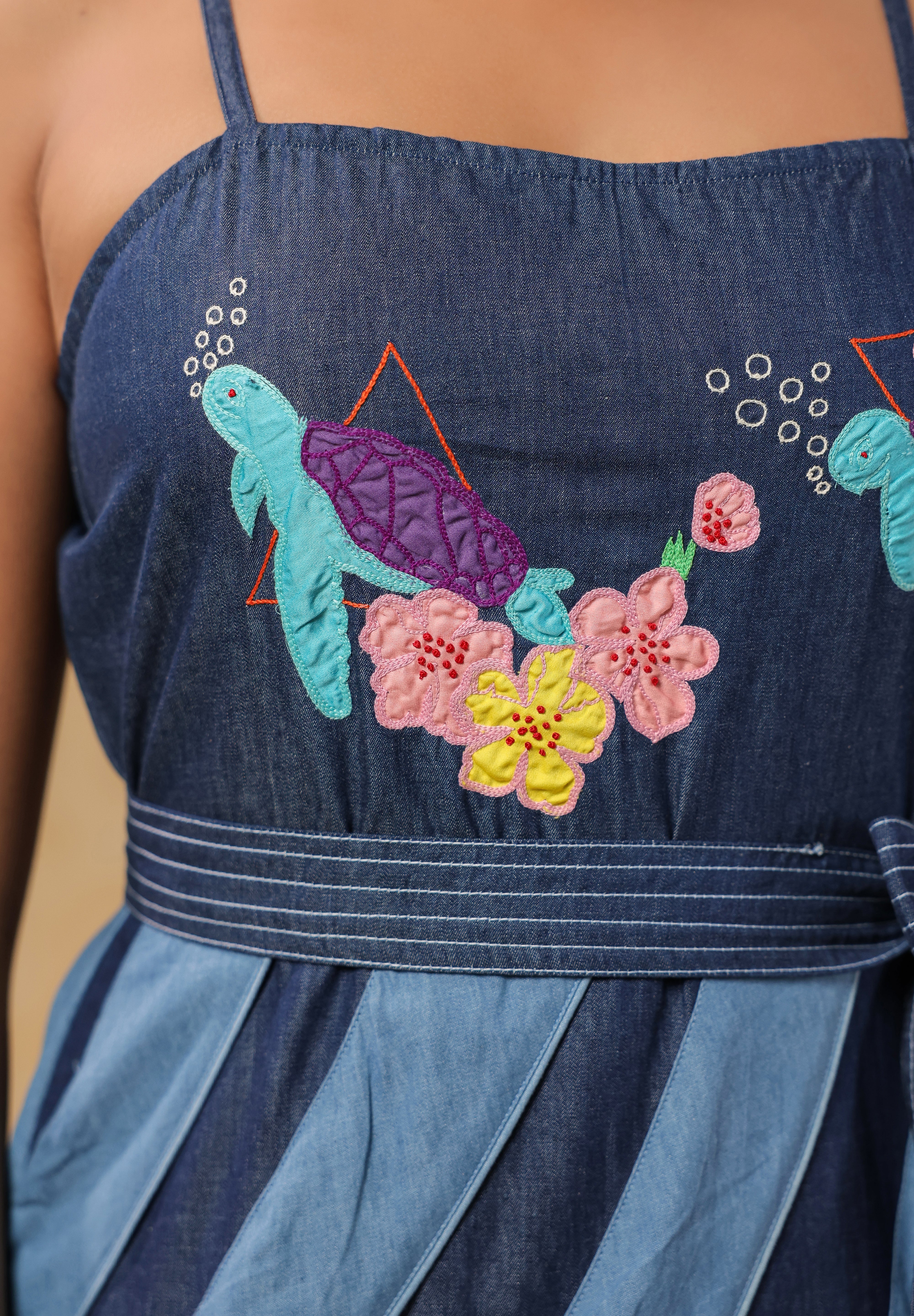 Close-up of turtle and floral embroidery on the bodice of Turtletide Flare Dress with intricate stitching