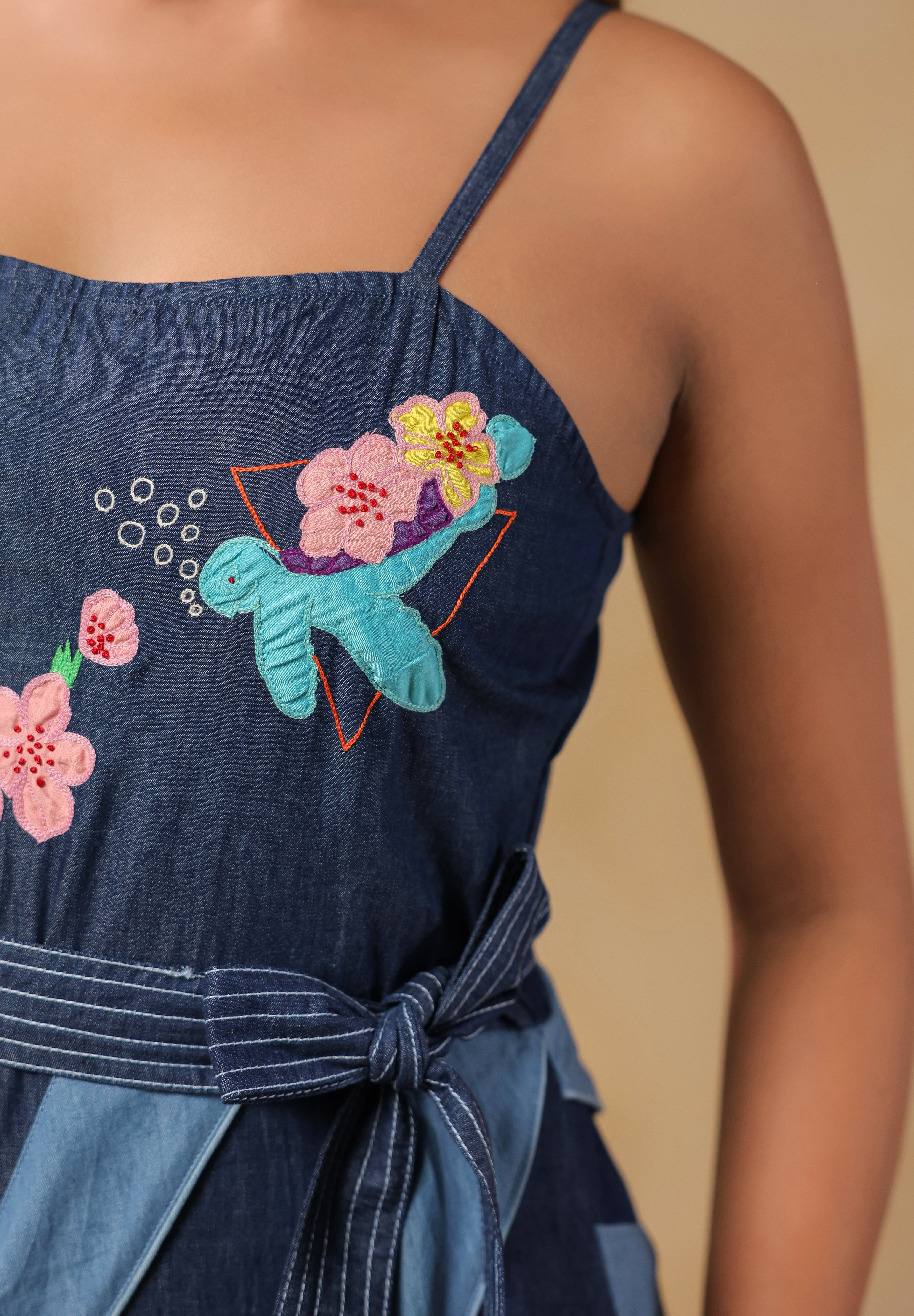 Close-up of turtle and floral embroidery on the bodice of Turtletide Flare Dress with intricate stitching