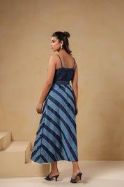 Back view of Turtletide Flare Dress showing denim spiral flare panels and belted waist design