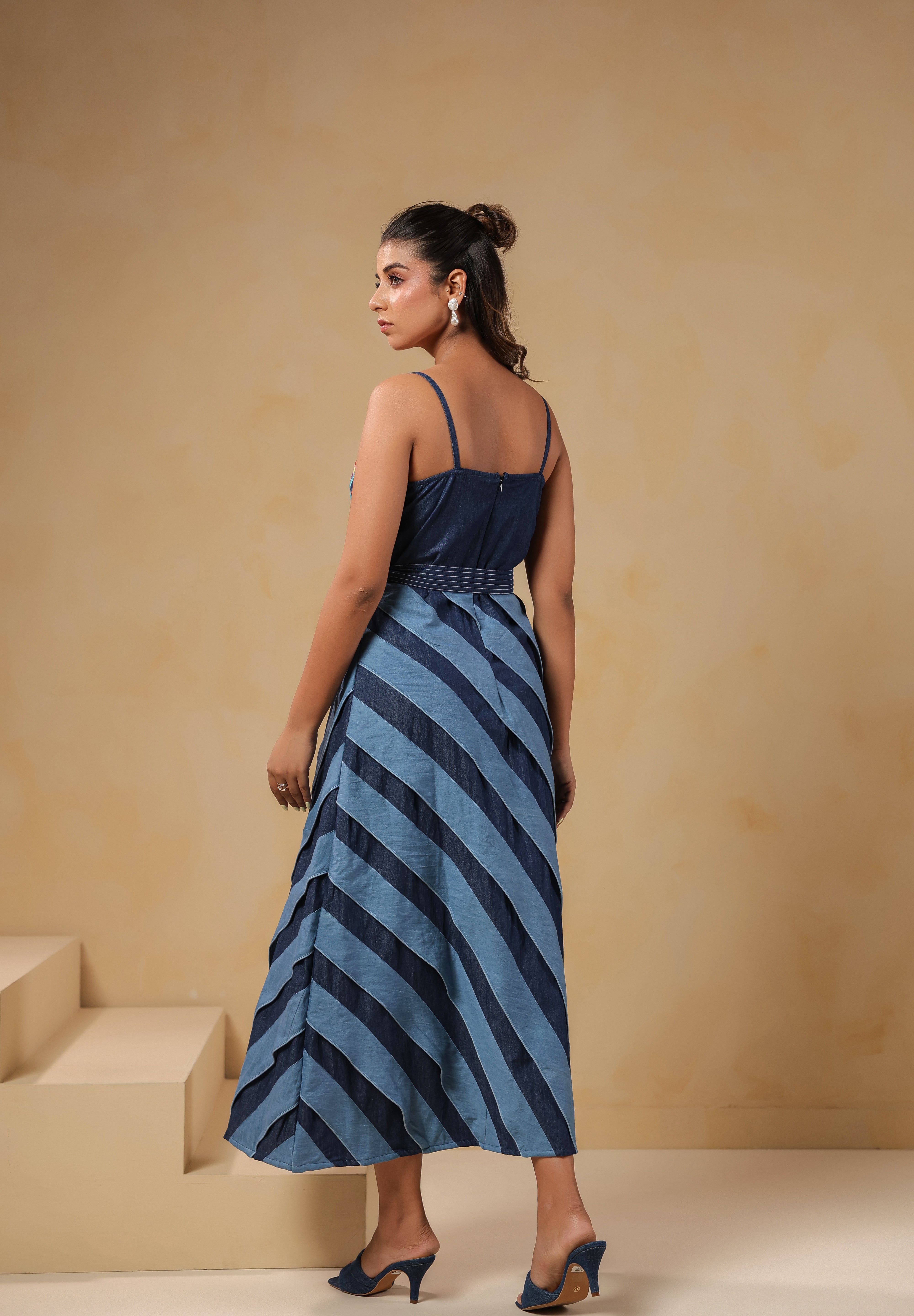 Back view of Turtletide Flare Dress showing denim spiral flare panels and belted waist design