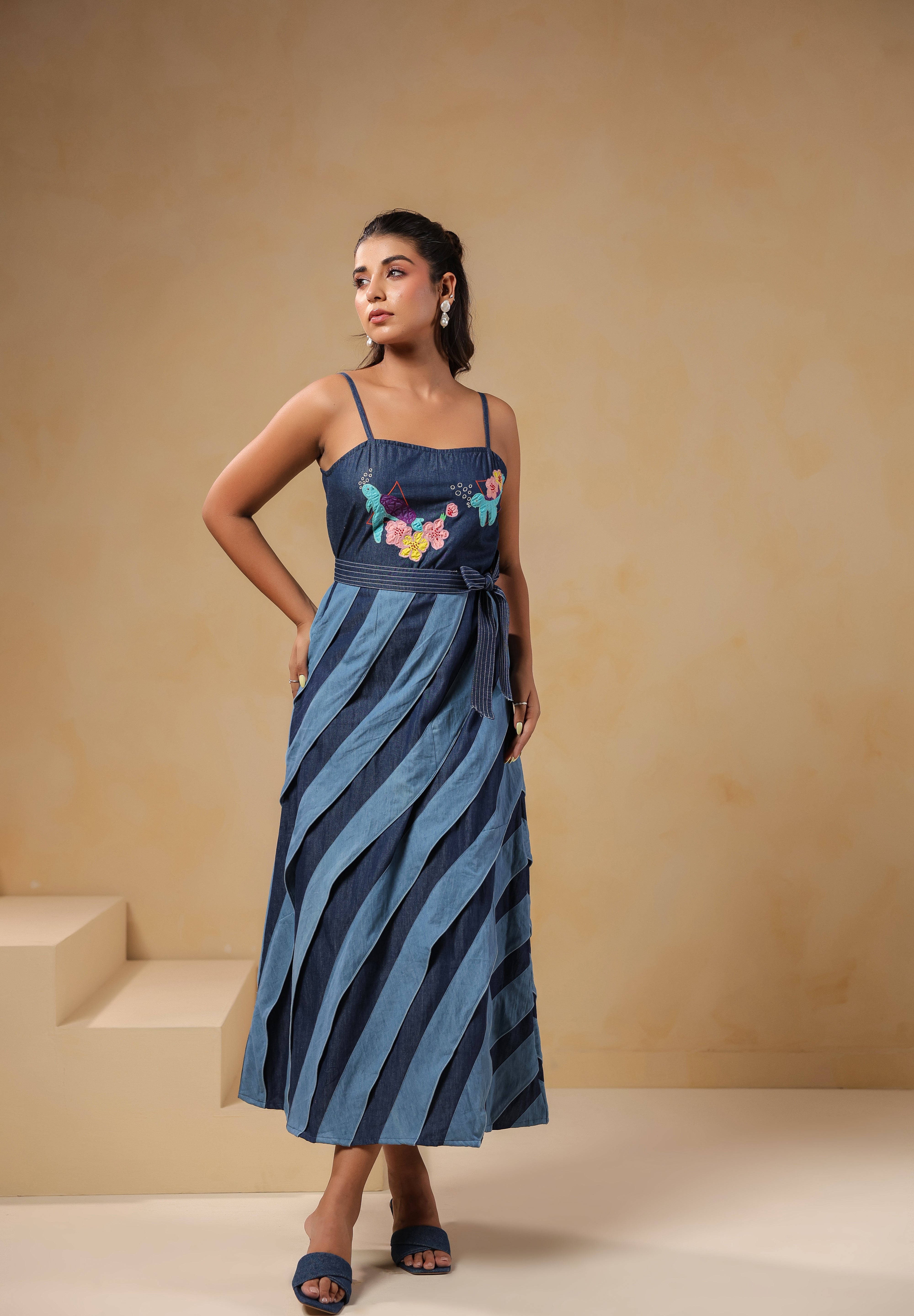 Relaxed pose in Turtletide Flare Dress with soft denim drape, belted waist, and embroidered turtle floral accents